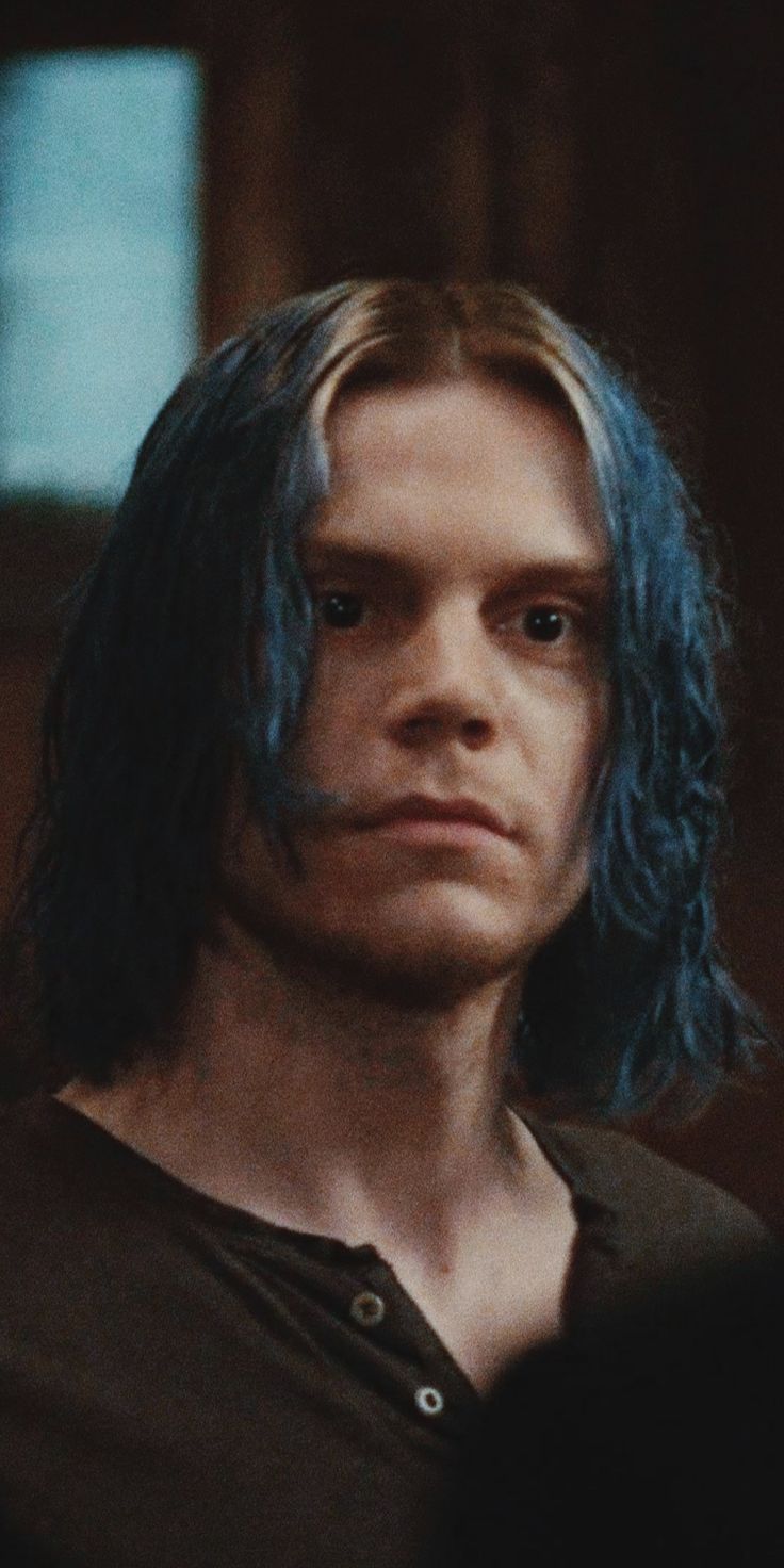 Blue hair guy with a serious look on his face - Evan Peters