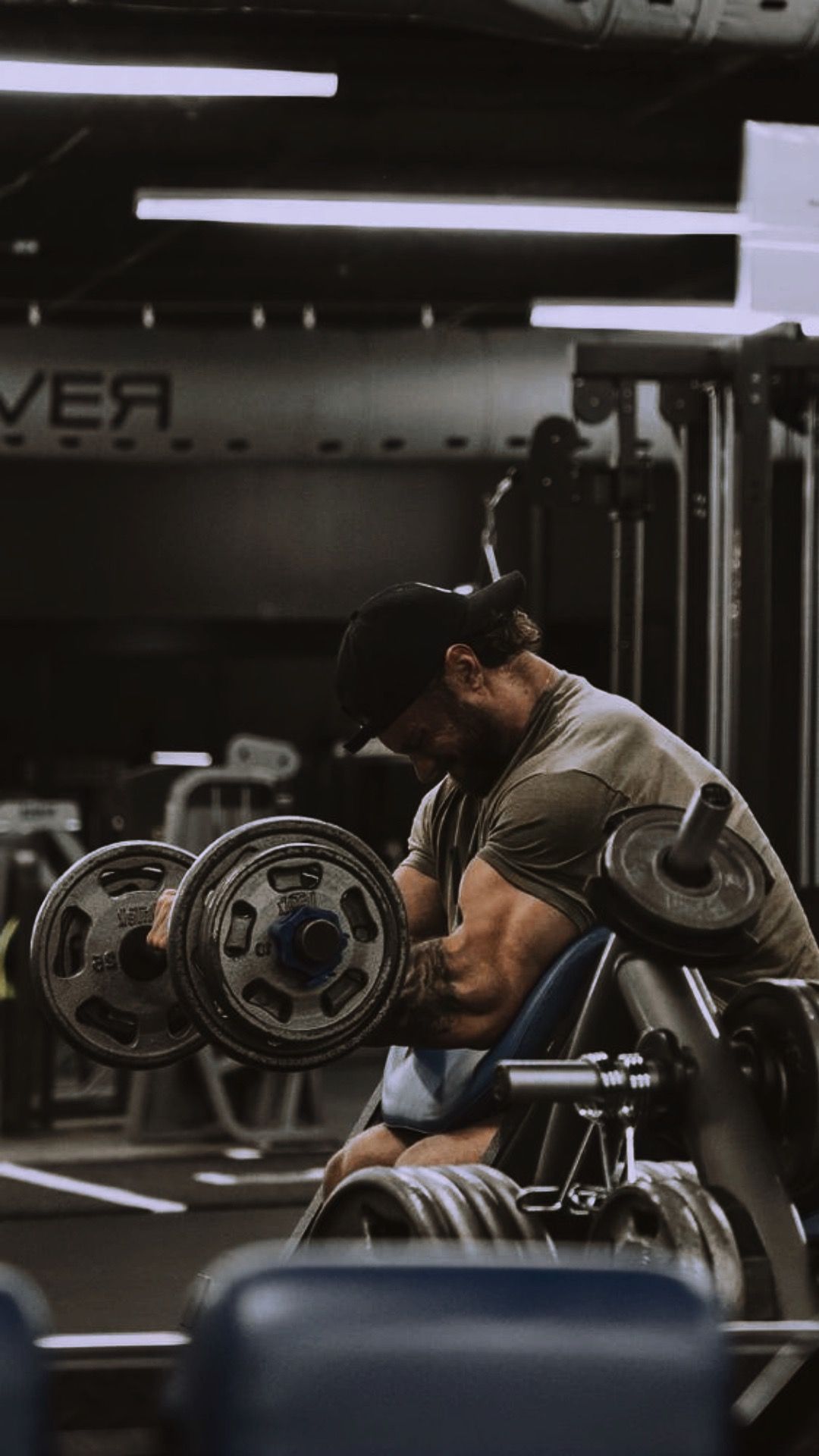 A man lifting weights in a gym - Gym