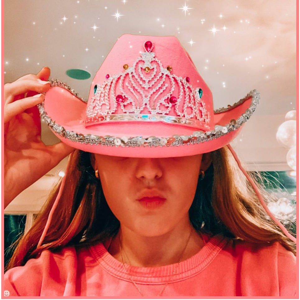 A girl wearing pink cowboy hat with crown - Cowgirl