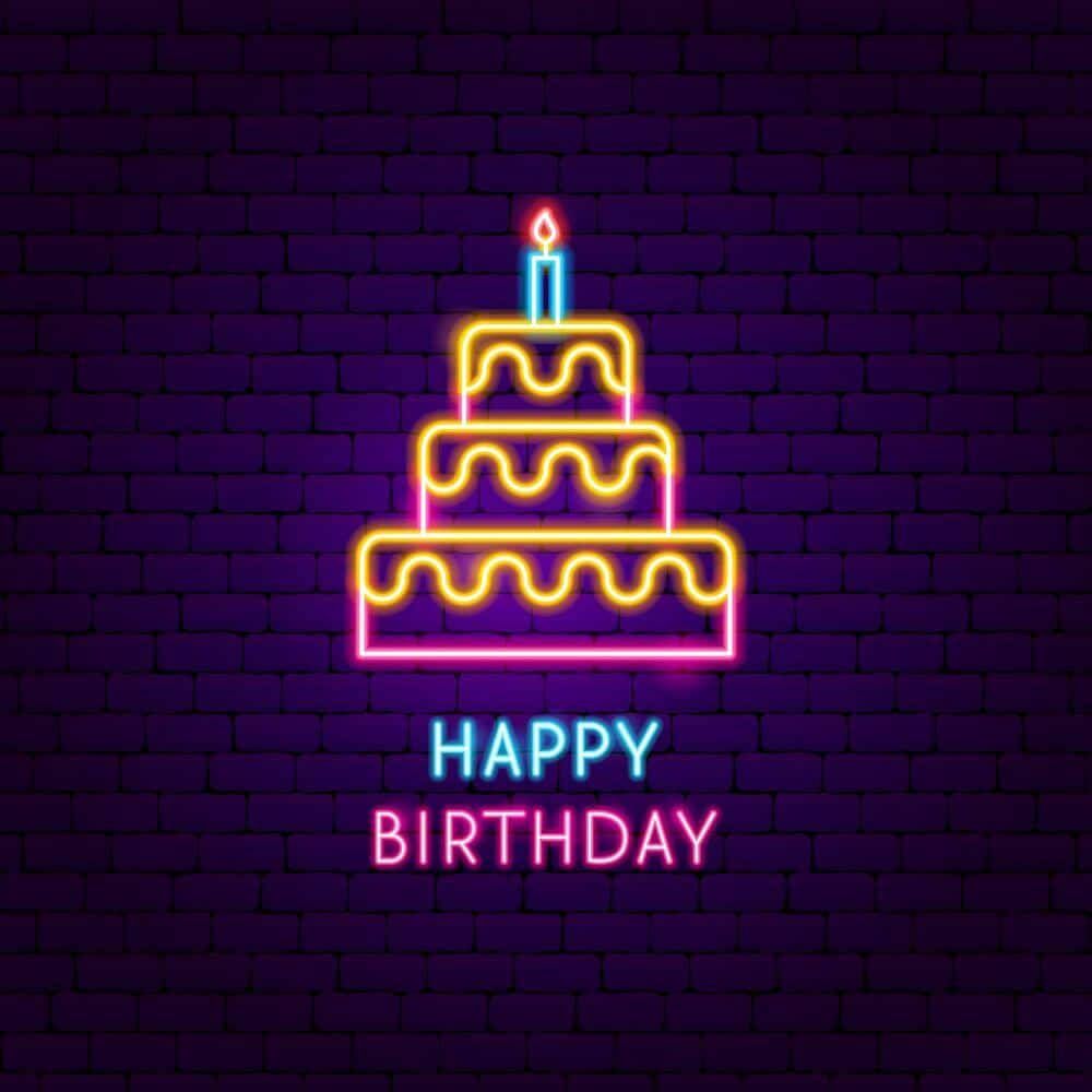 A neon sign with a cake and a candle on it - Birthday