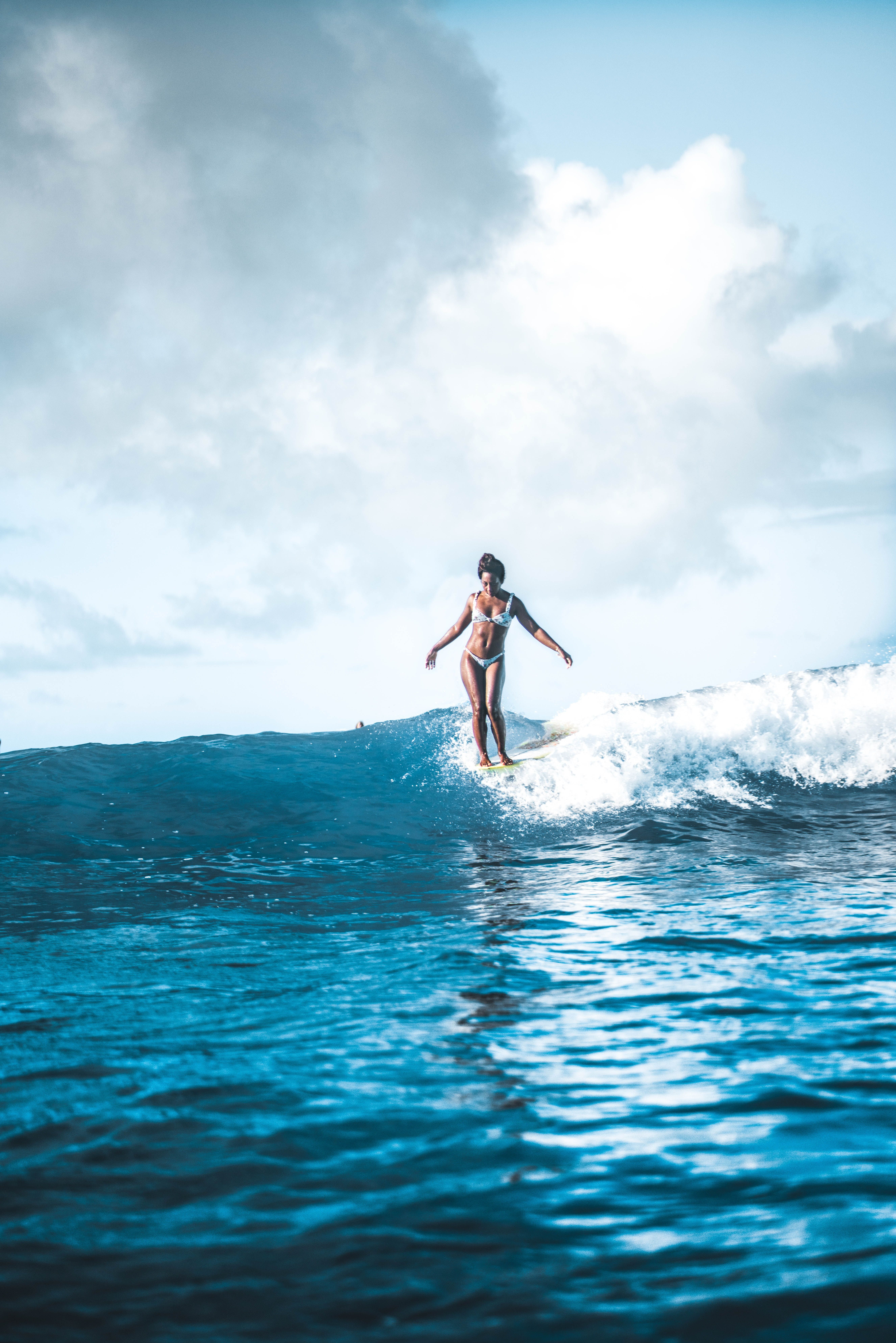 A woman riding on top of an ocean wave - Wave, surf