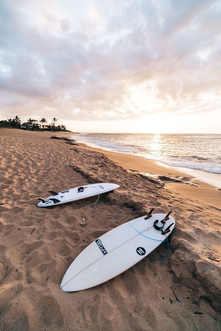 Two surfboards laying on the beach at sunset - Surf