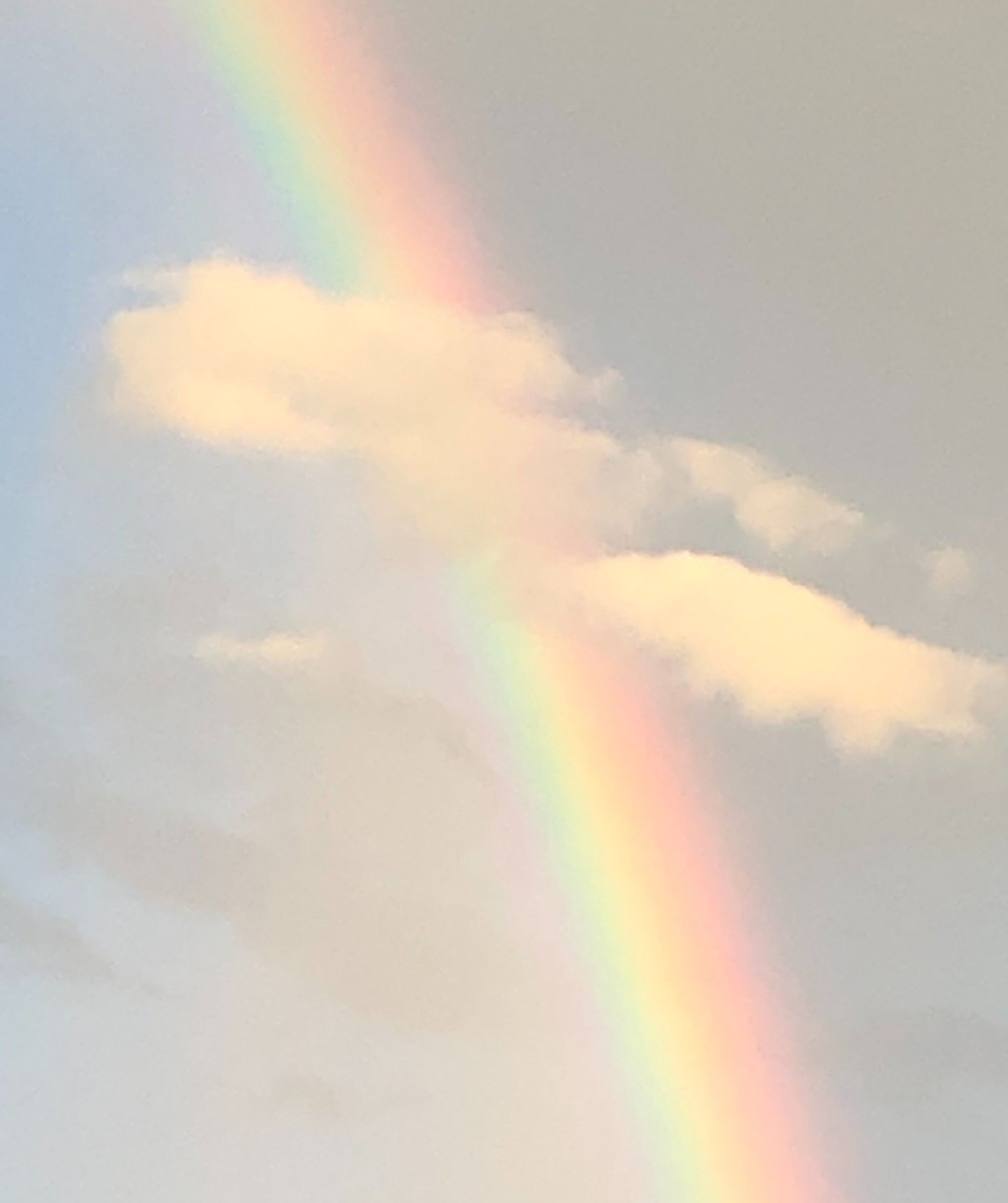 A double rainbow appears in a cloudy sky. - Vintage clouds