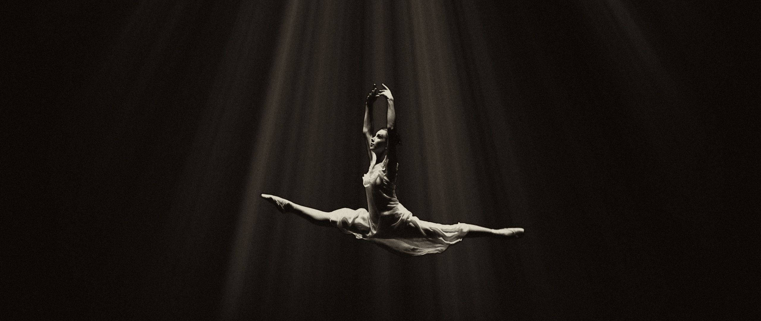 A woman doing an aerial act in the dark - Dance, ballet