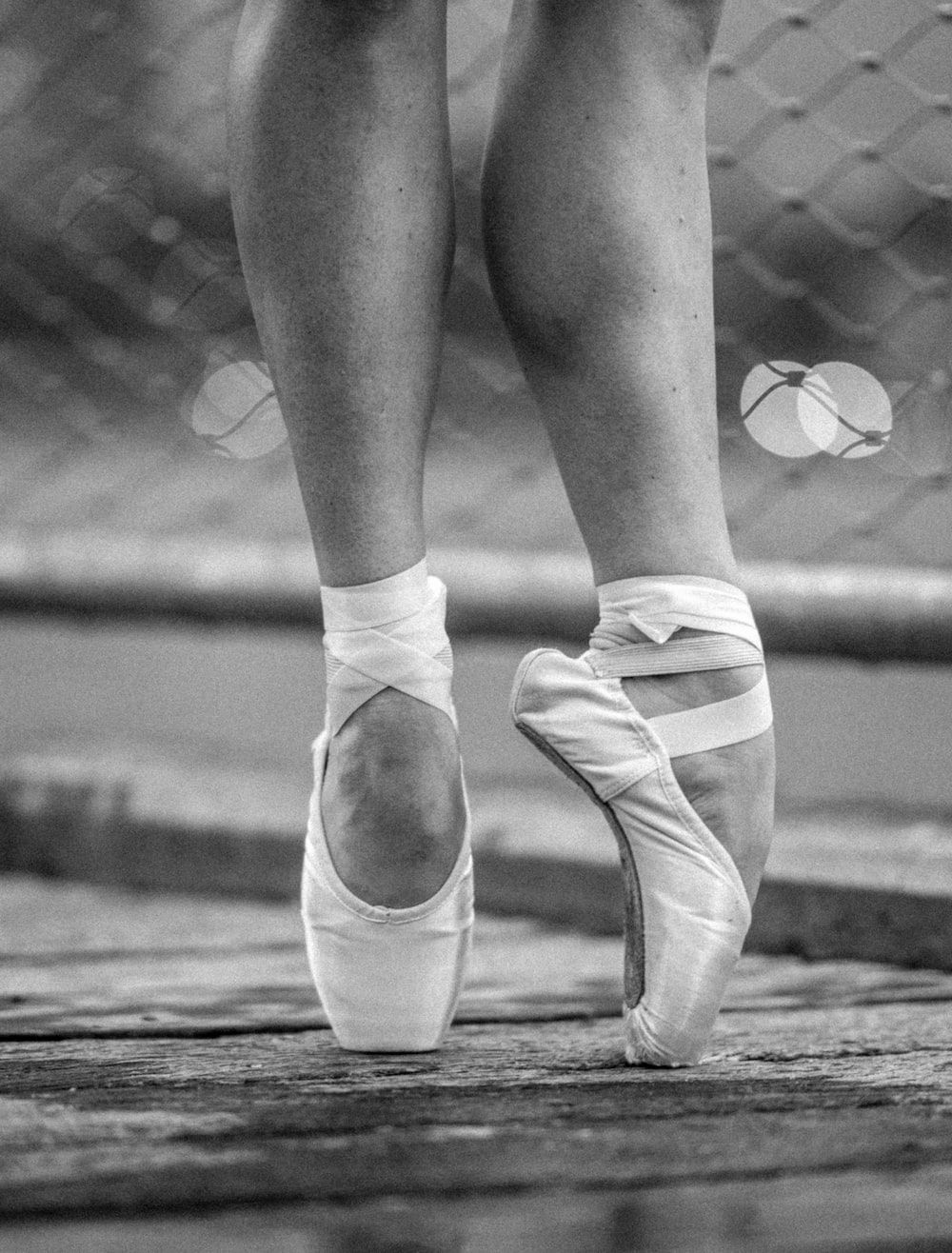 A black and white photo of a ballerina's feet in pointe shoes. - Dance, ballet