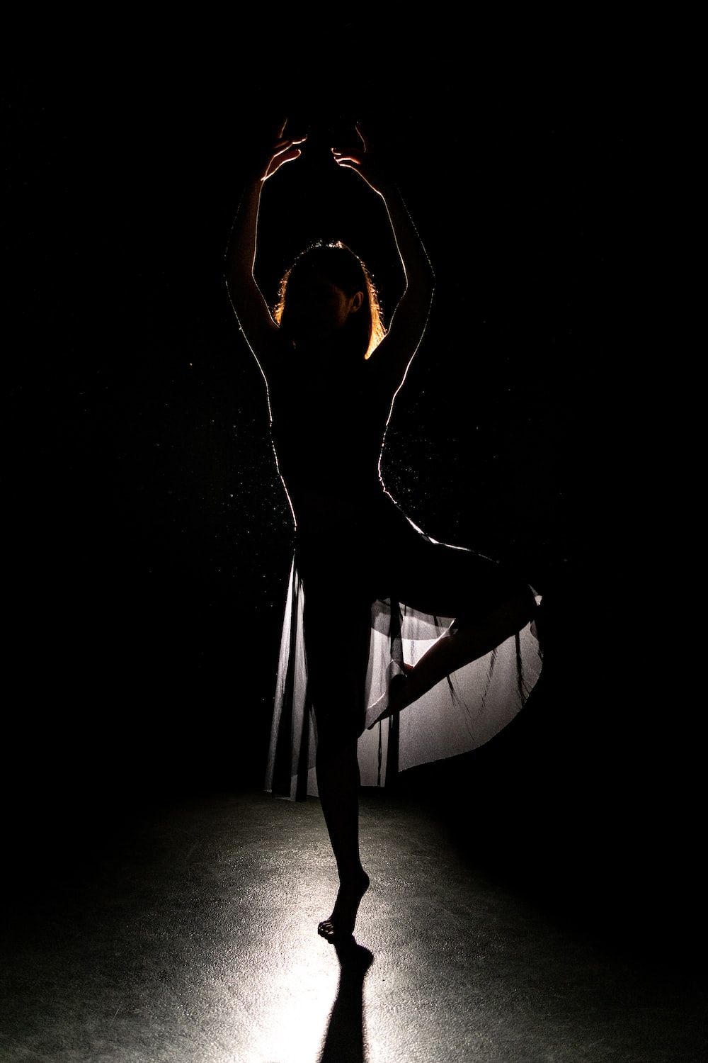 A woman is dancing in the dark - Ballet, dance