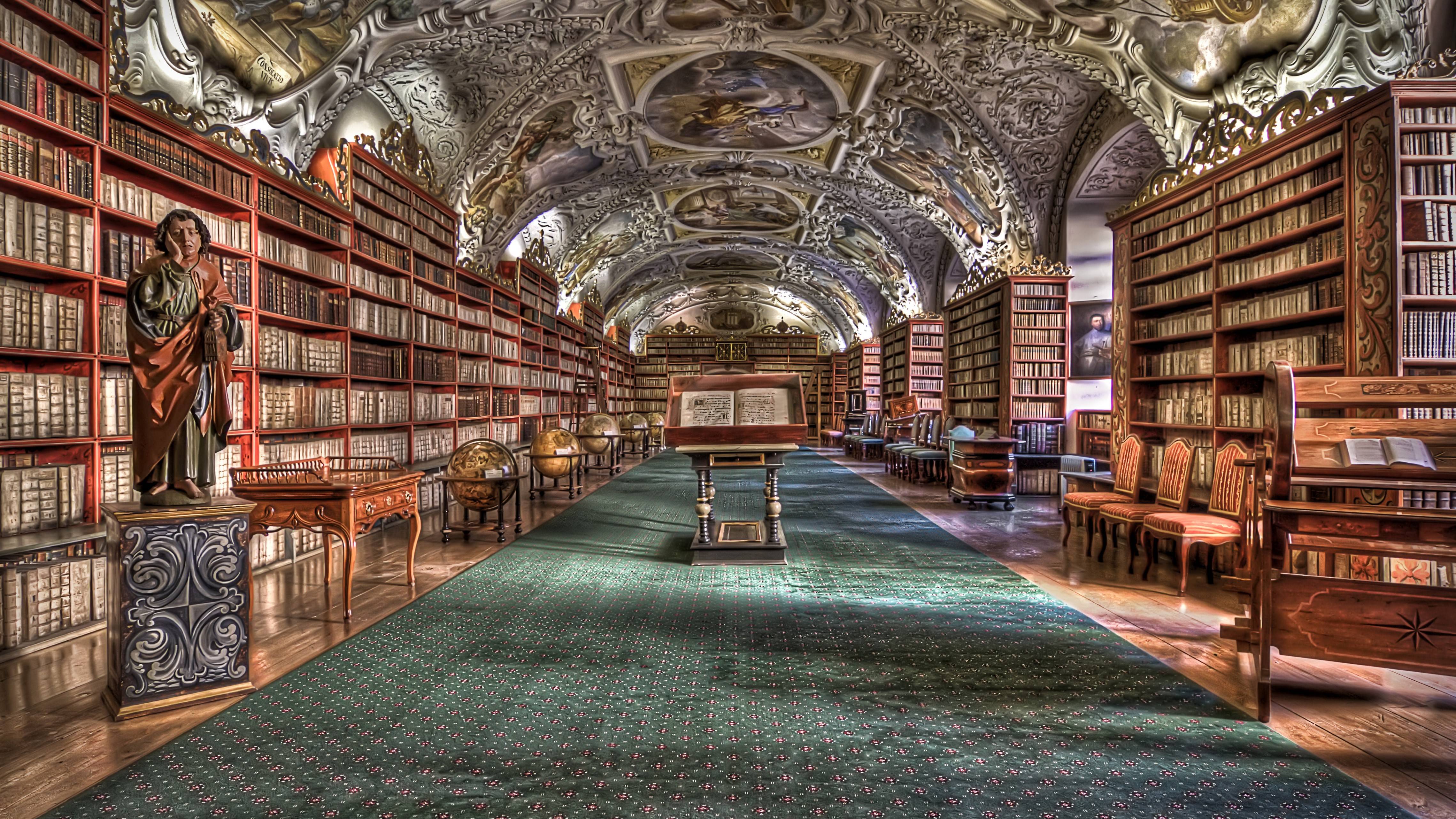 The library is full of books and has a green carpet. - Library