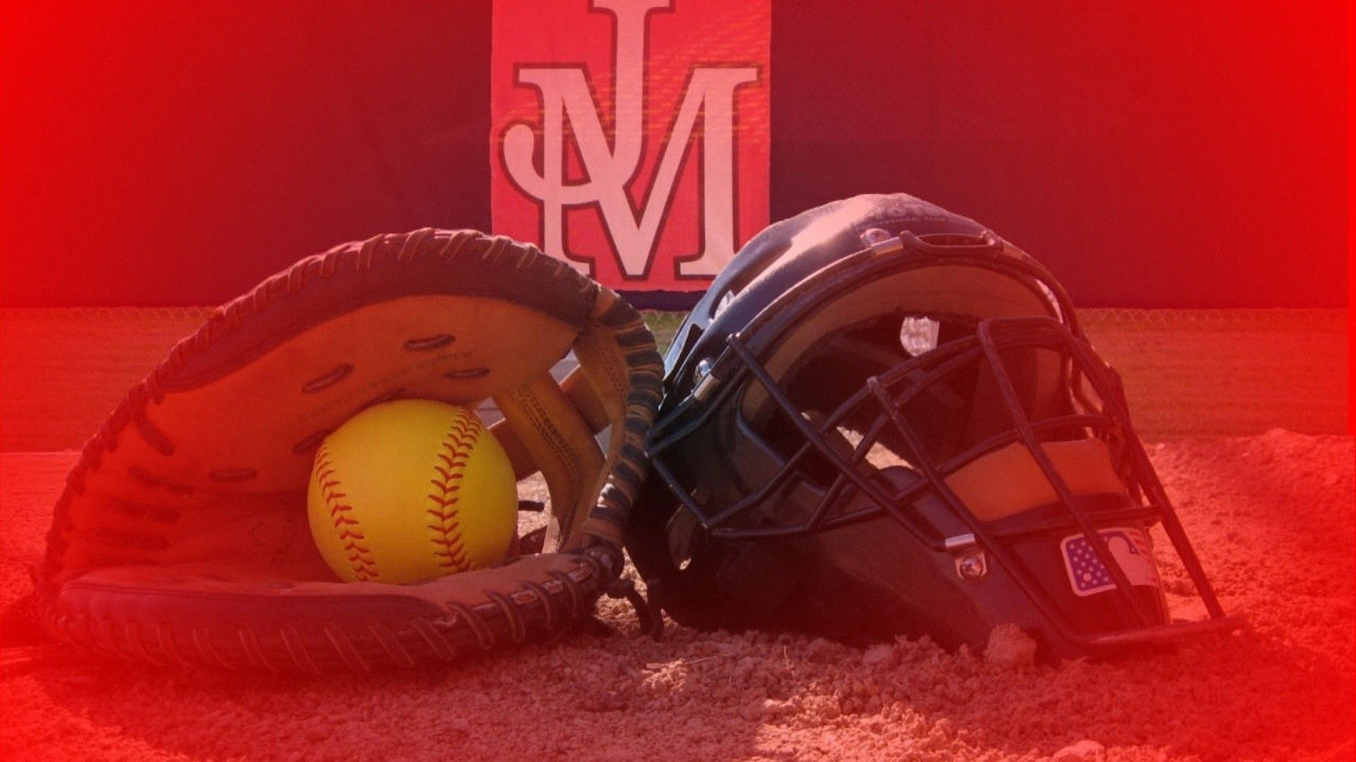A softball and helmet on the field with a red background and the letters M and J in the background. - Softball
