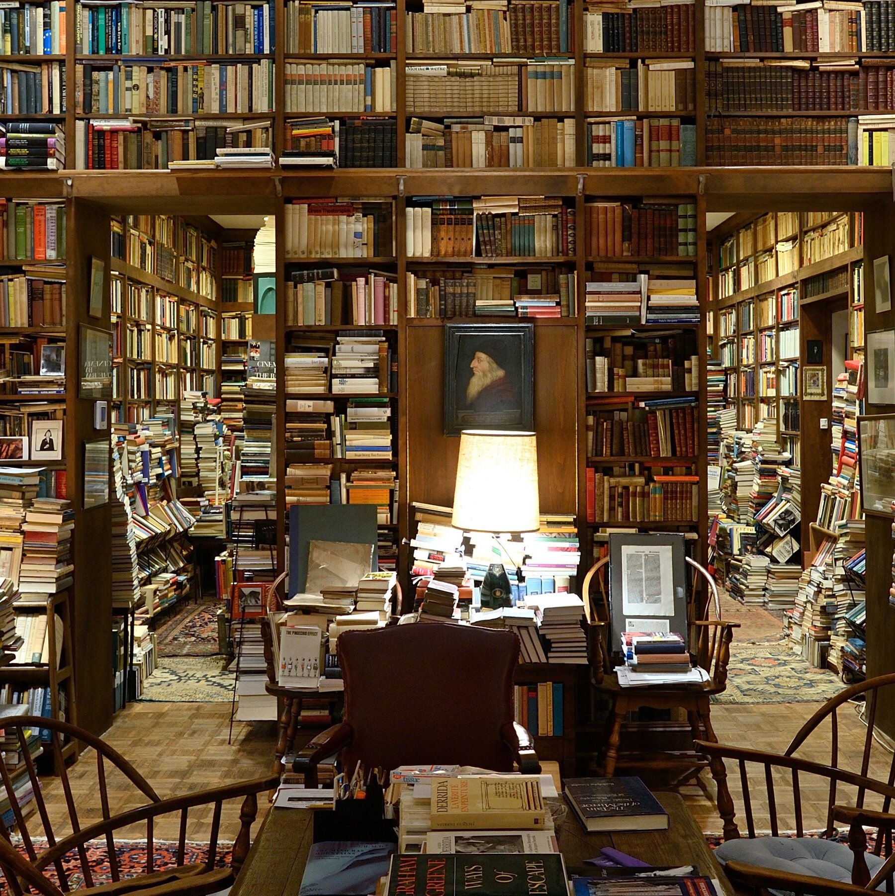 A room filled with many books and chairs - Library