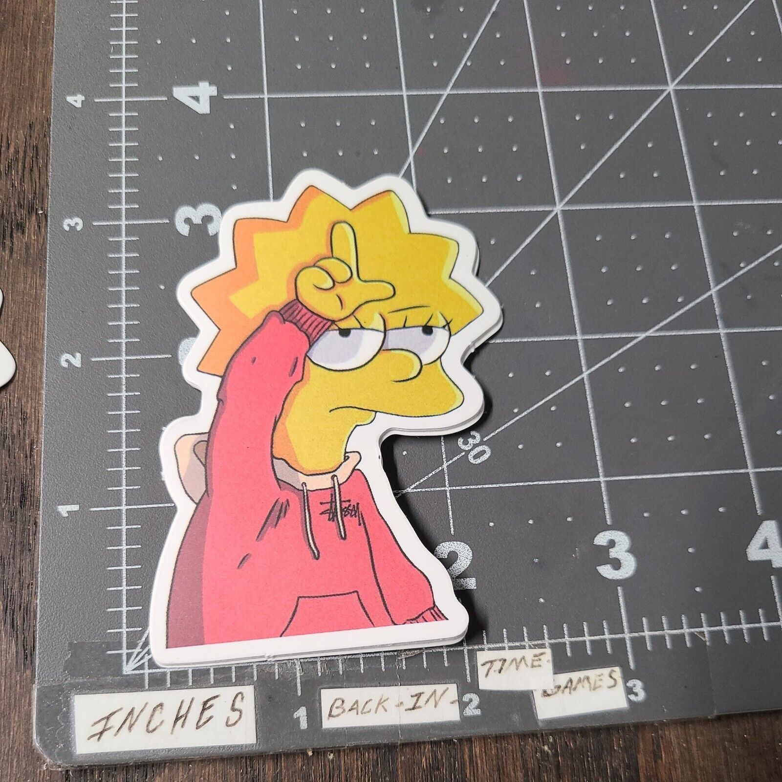 A sticker of the simpsons character is on top - Lisa Simpson