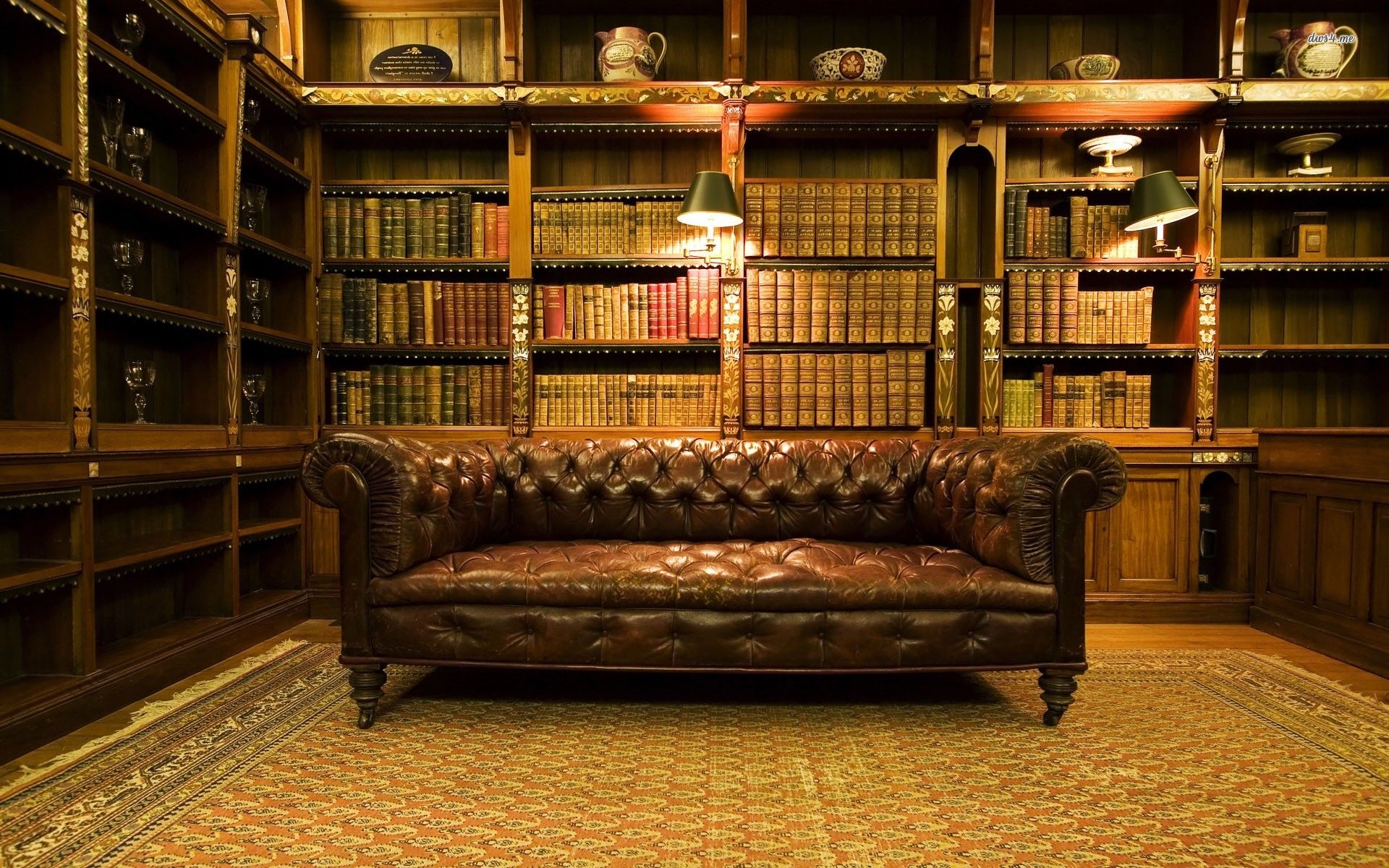 A leather couch in a room with bookshelves. - Library