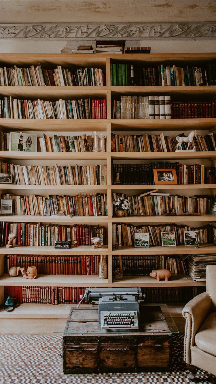 A room with many books and an old typewriter - Library, books