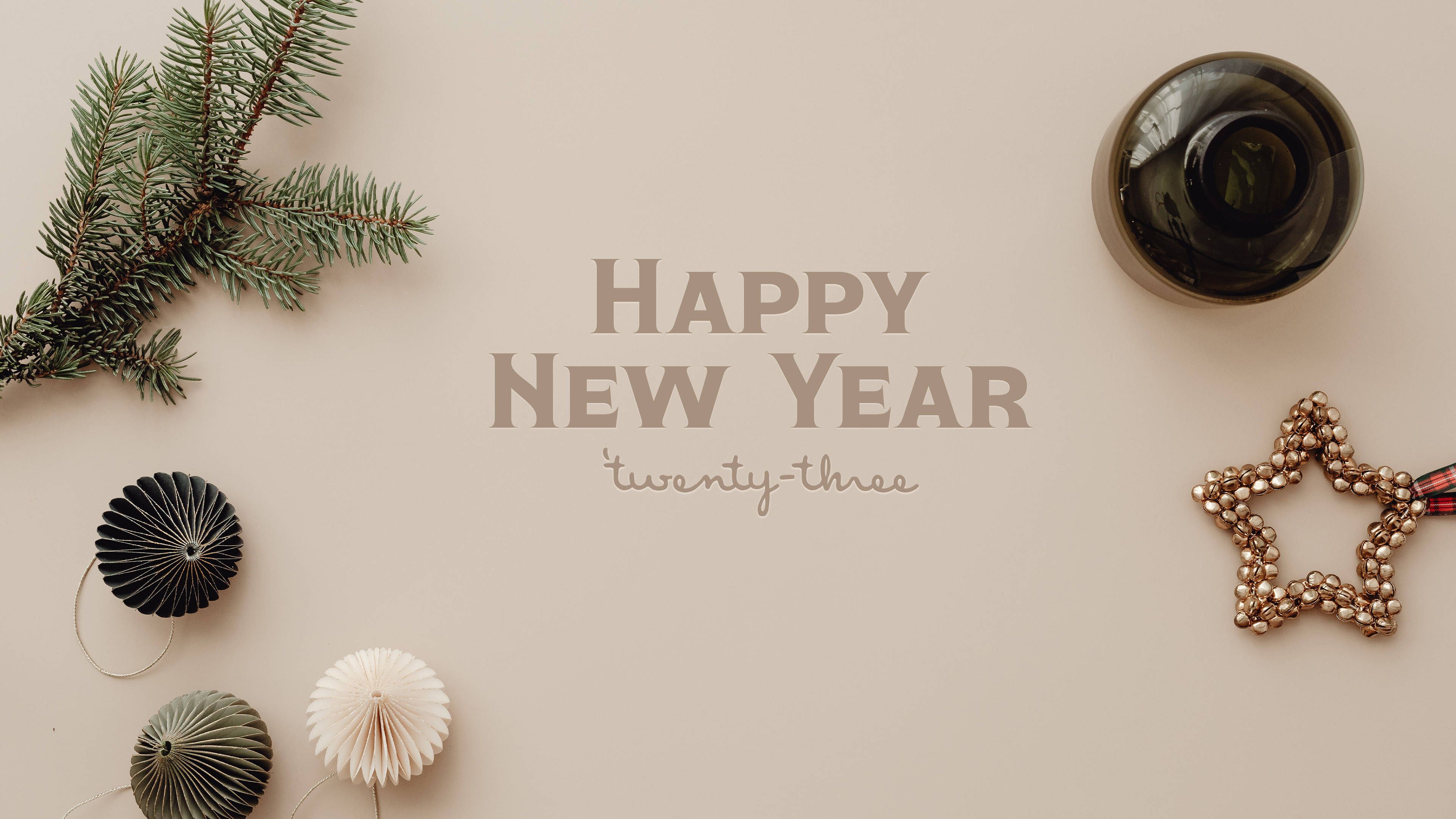 Happy New Year 2023 text with a pine branch and Christmas decorations on a beige background - New Year