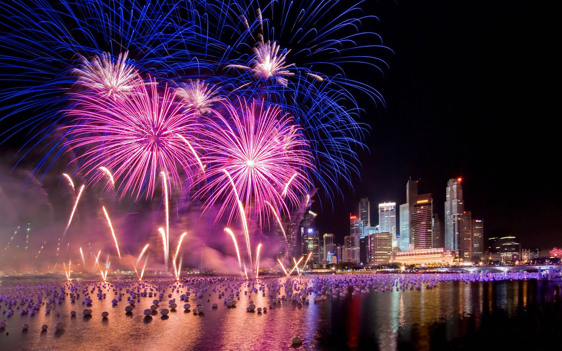A large fireworks display over the water - New Year