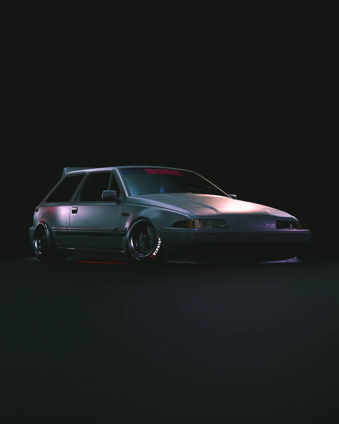 A grey car with red lights on the side in a dark room. - JDM