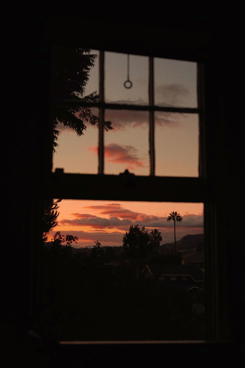 A window with the sun setting behind it - Photography