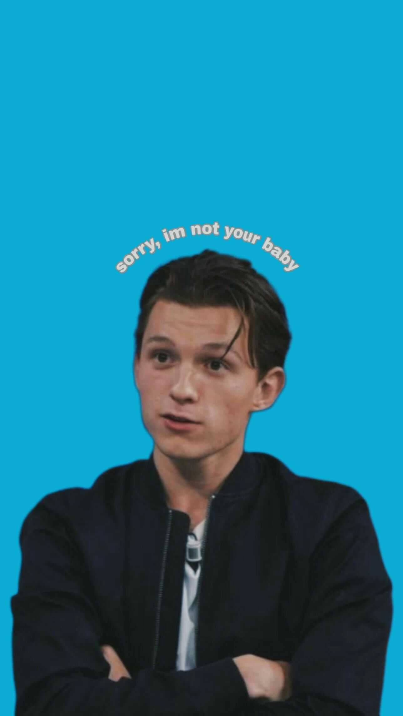 A man with his arms crossed and the words sorry not you - Tom Holland