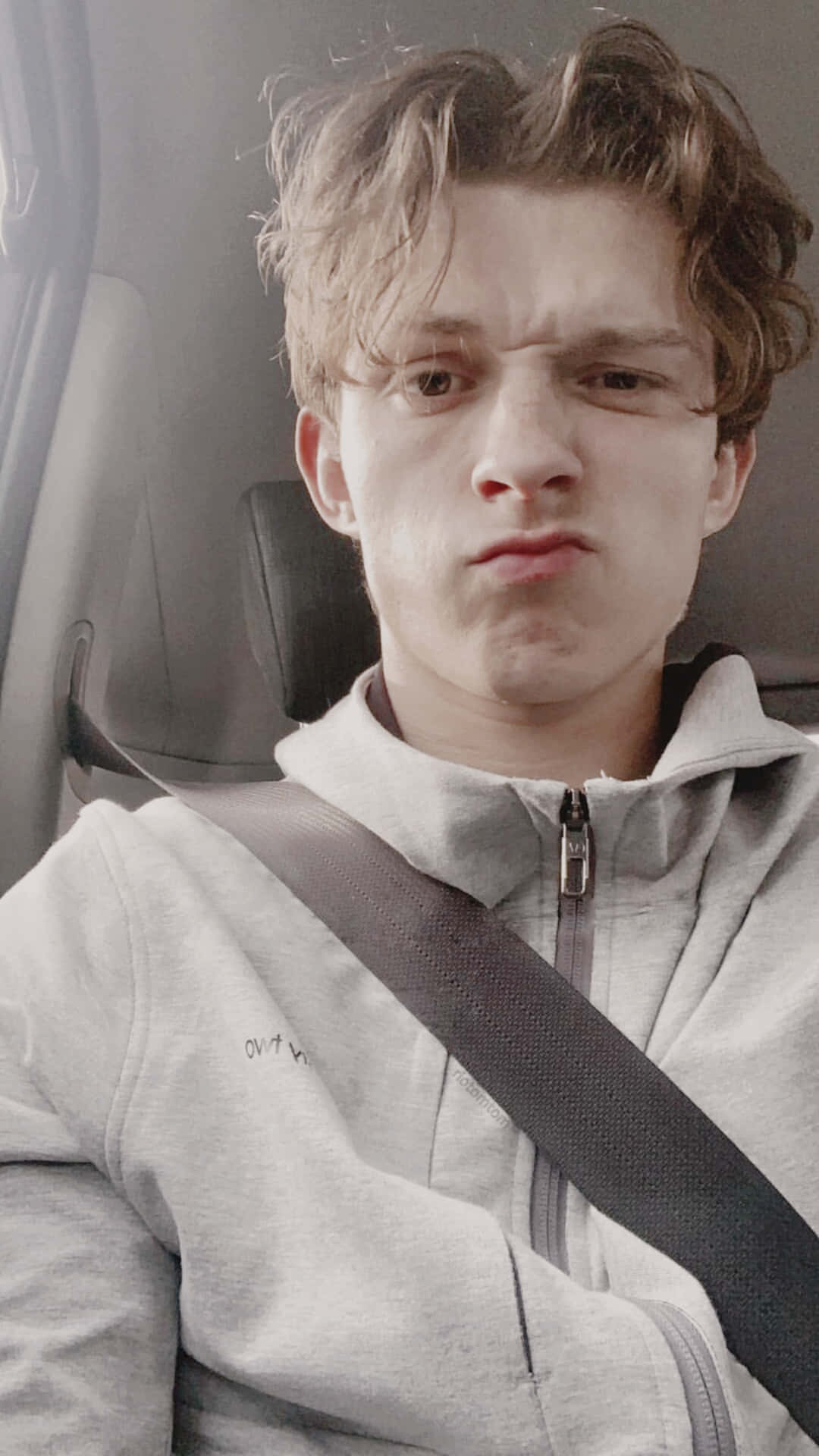 Tom Holland looking confused in the back of a car - Tom Holland