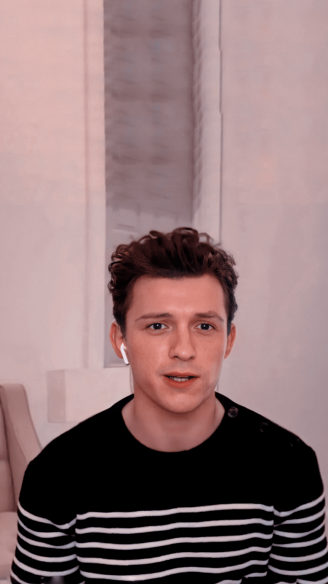 Tom Holland wearing a black and white striped shirt. - Tom Holland