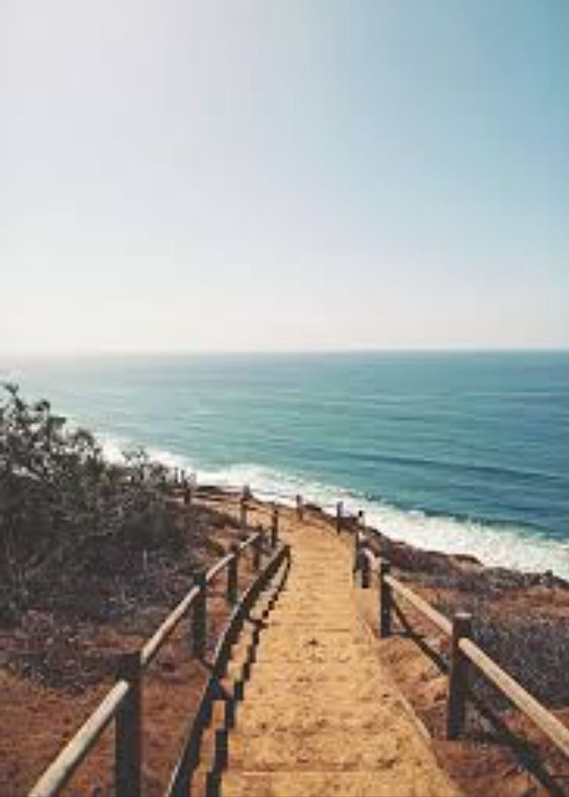 A wooden staircase leads down to the ocean - Beach, coast