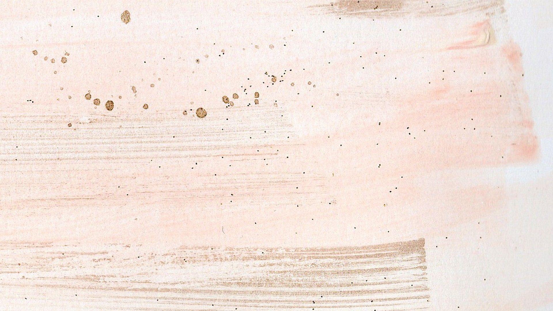 A close up of a piece of paper with pink and brown watercolor - MacBook