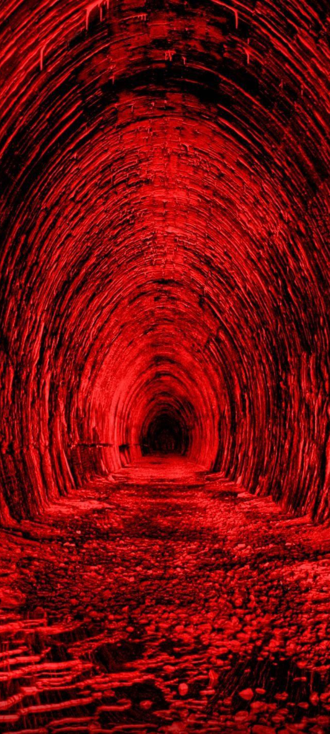 A red tunnel that leads to a dark tunnel. - Red