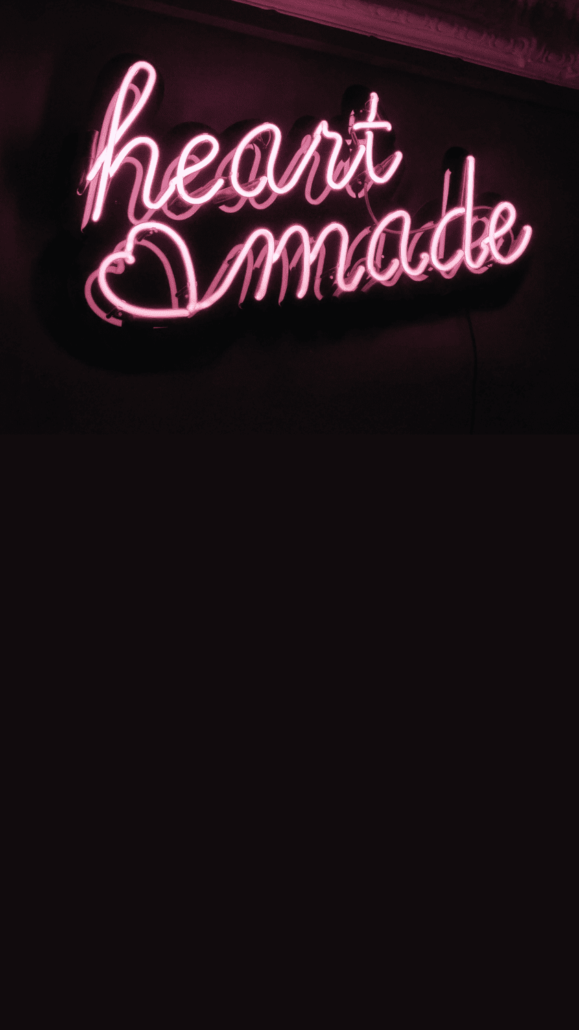 A neon sign that says heart made - Punk