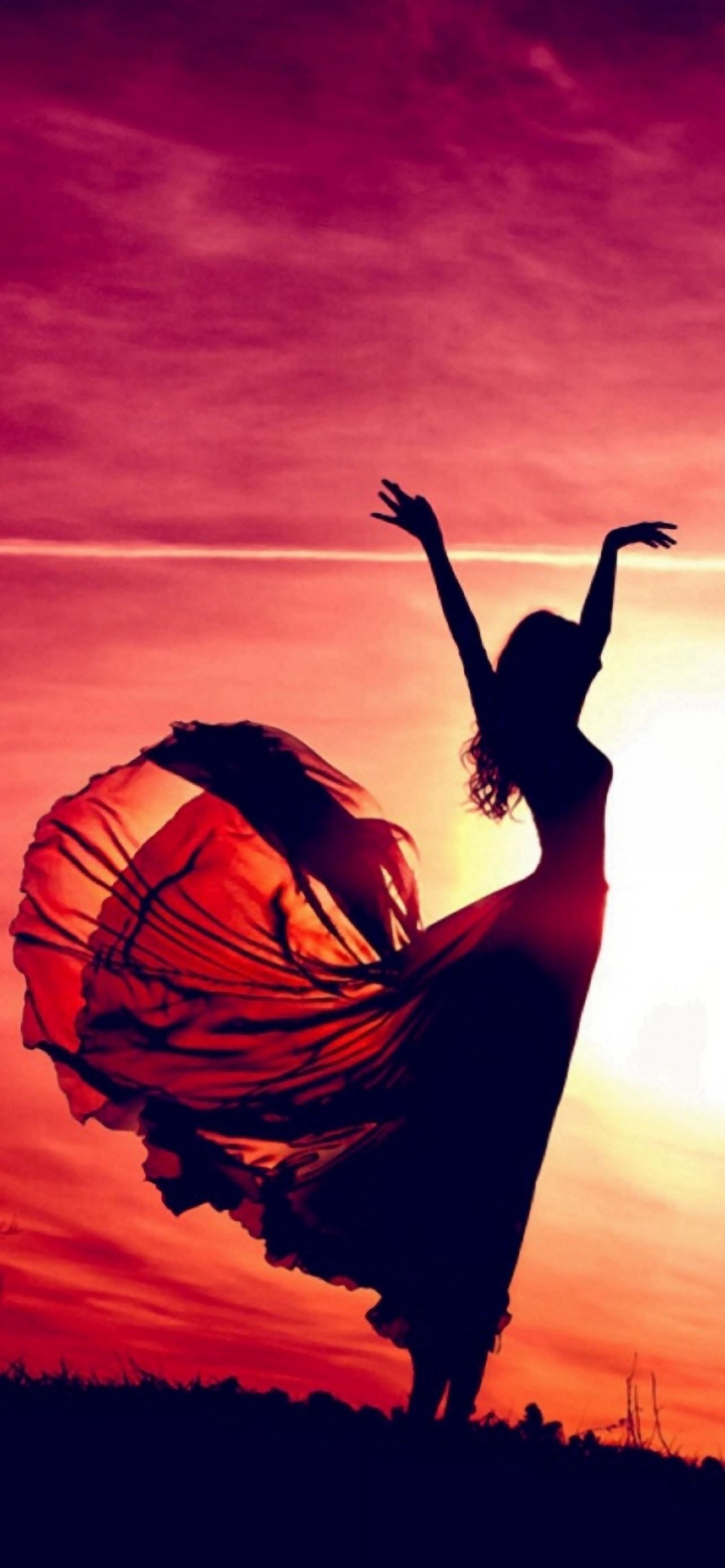 A woman dances in the sunset with her arms in the air. - Sunshine, beautiful, sunlight, dance