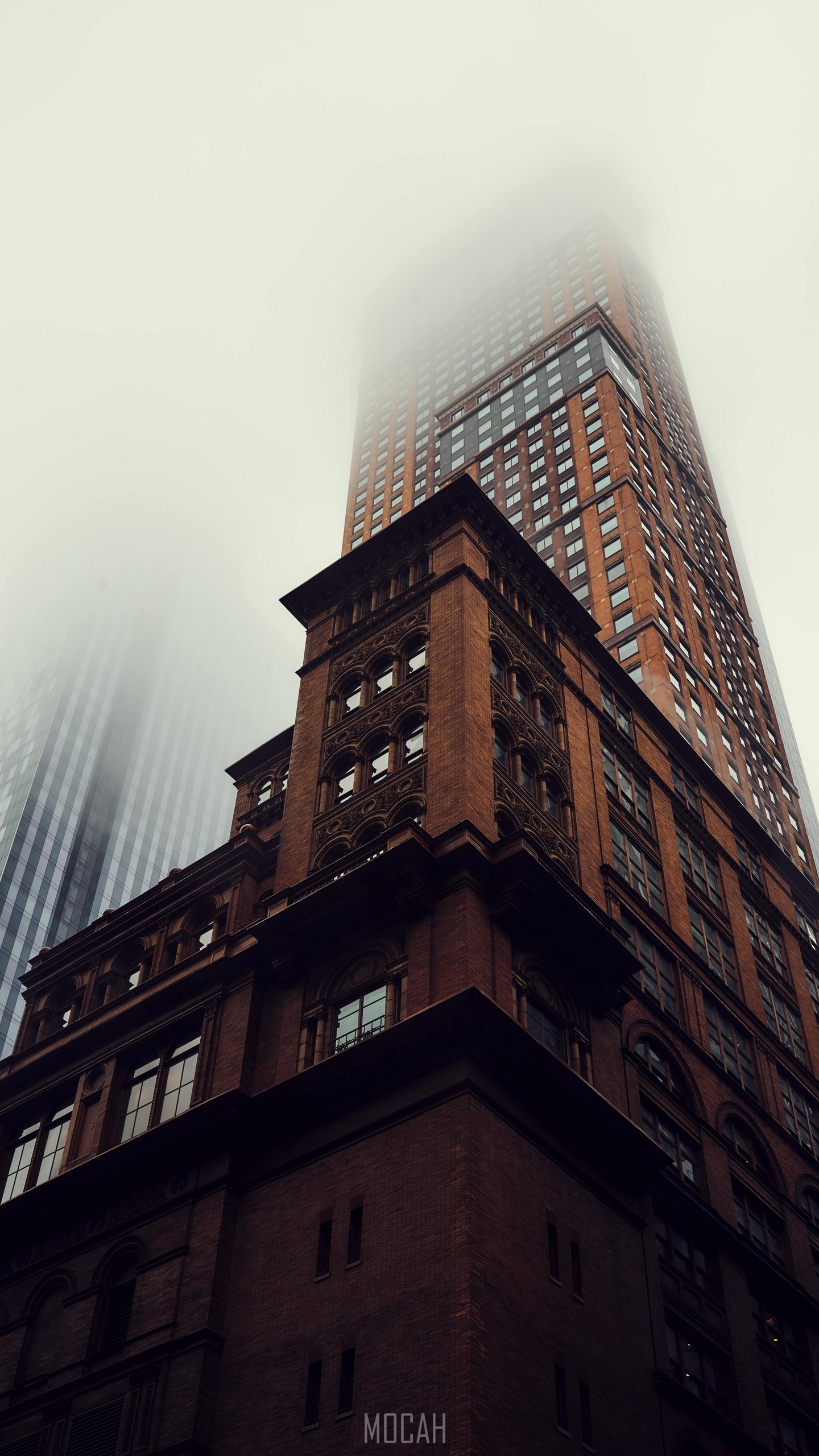 a ground view of a dark brick skyscraper disappearing into fog in new york city, giant in the mist, TECNO Camon iACE2 wallpaper 1080p, 720x1440 Gallery HD Wallpaper