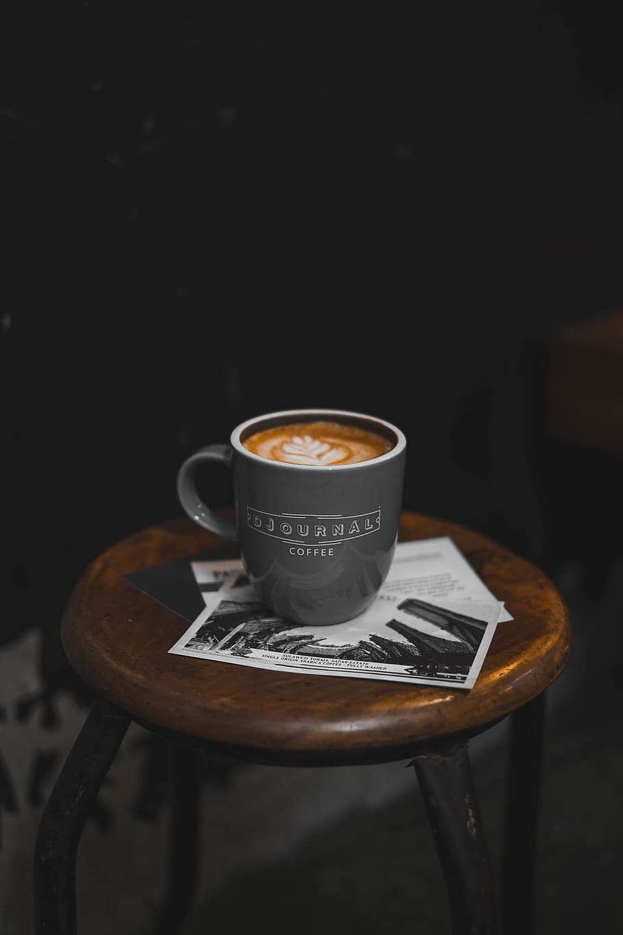 A cup of coffee with latte art on top of a table - Coffee