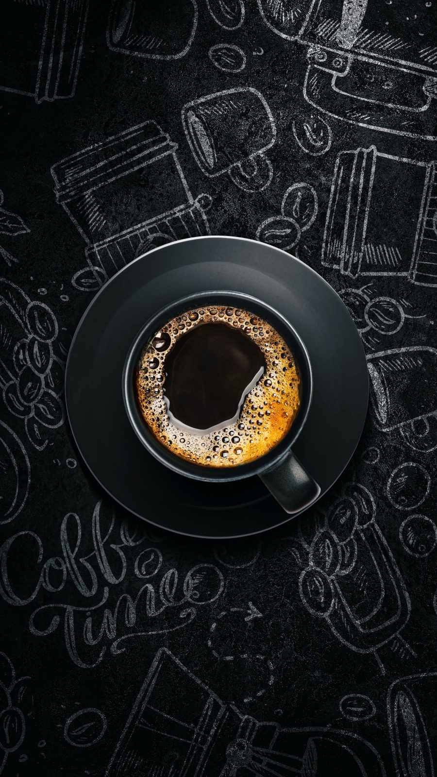 A cup of coffee on a black table with coffee time written on it - Coffee