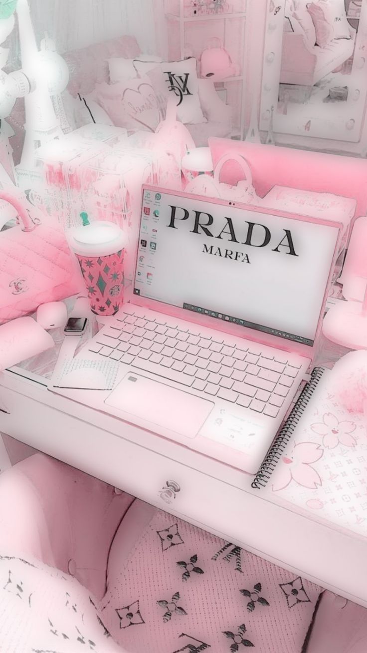 A pink laptop is sitting on top of the desk - Soft pink