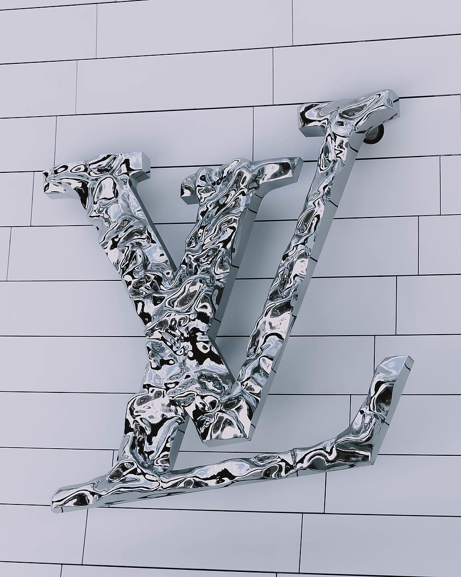 A silver lv sign on the wall - Louis Vuitton