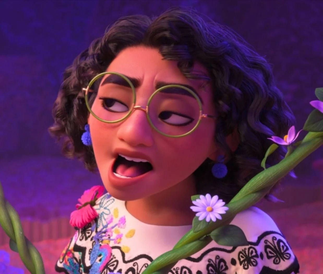 A still from Pixar's 'Coco' showing a character with curly hair and glasses holding flowers. - Encanto