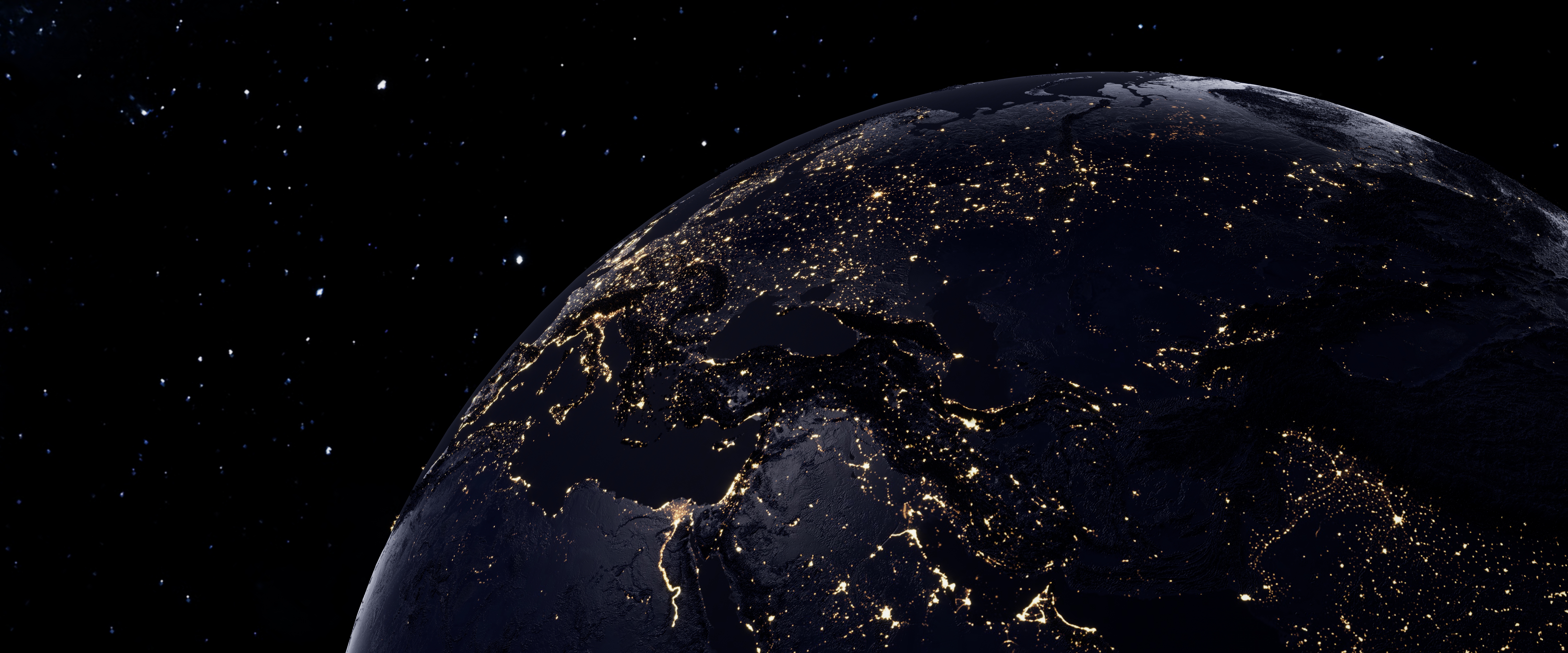 A globe with city lights glowing in the dark - Earth