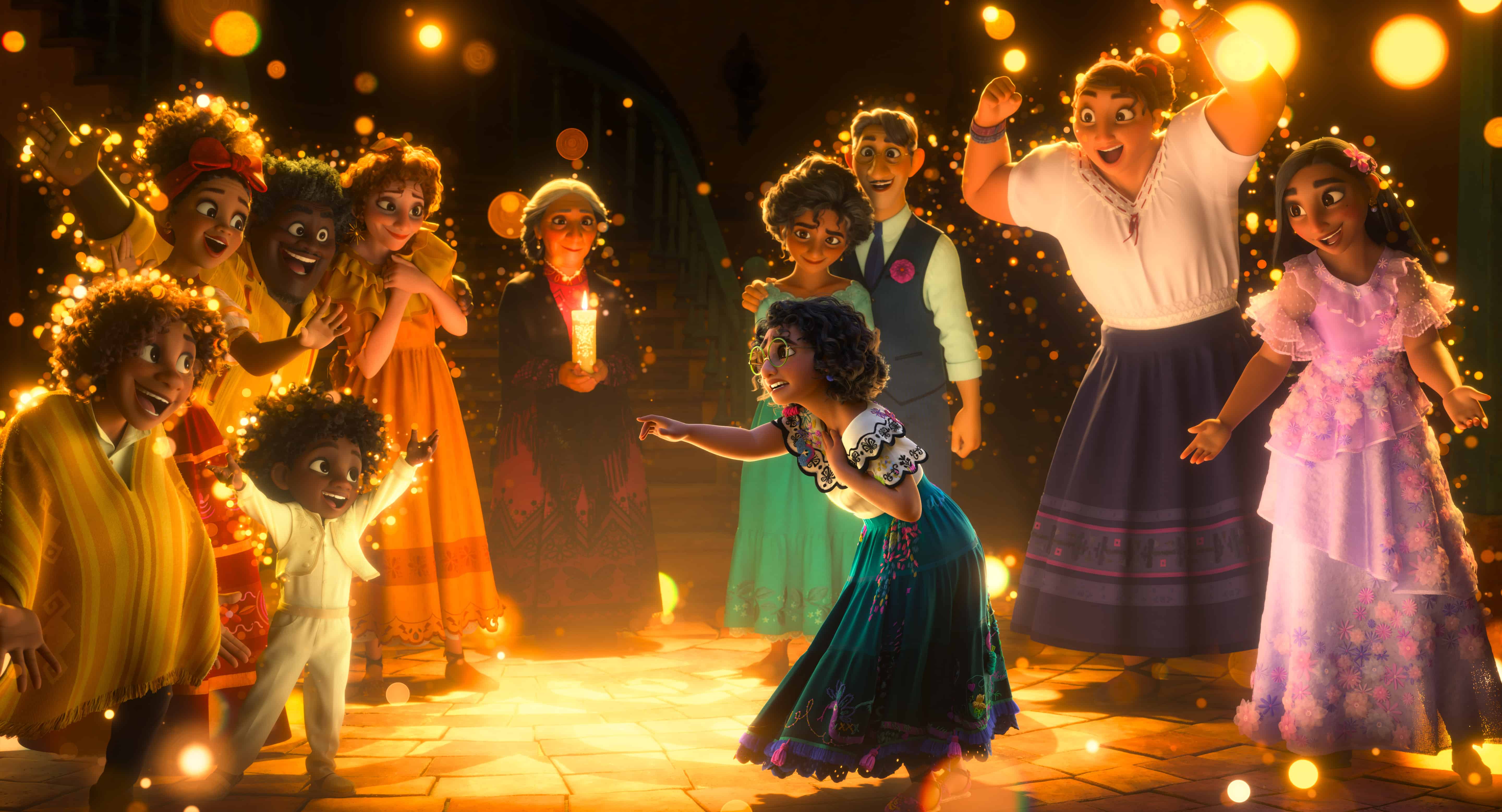 In Disney's Encanto, the Madrigal family members are seen wearing their vibrant, colorful outfits. In the center of the image, a young girl dances with her arms outstretched. - Encanto