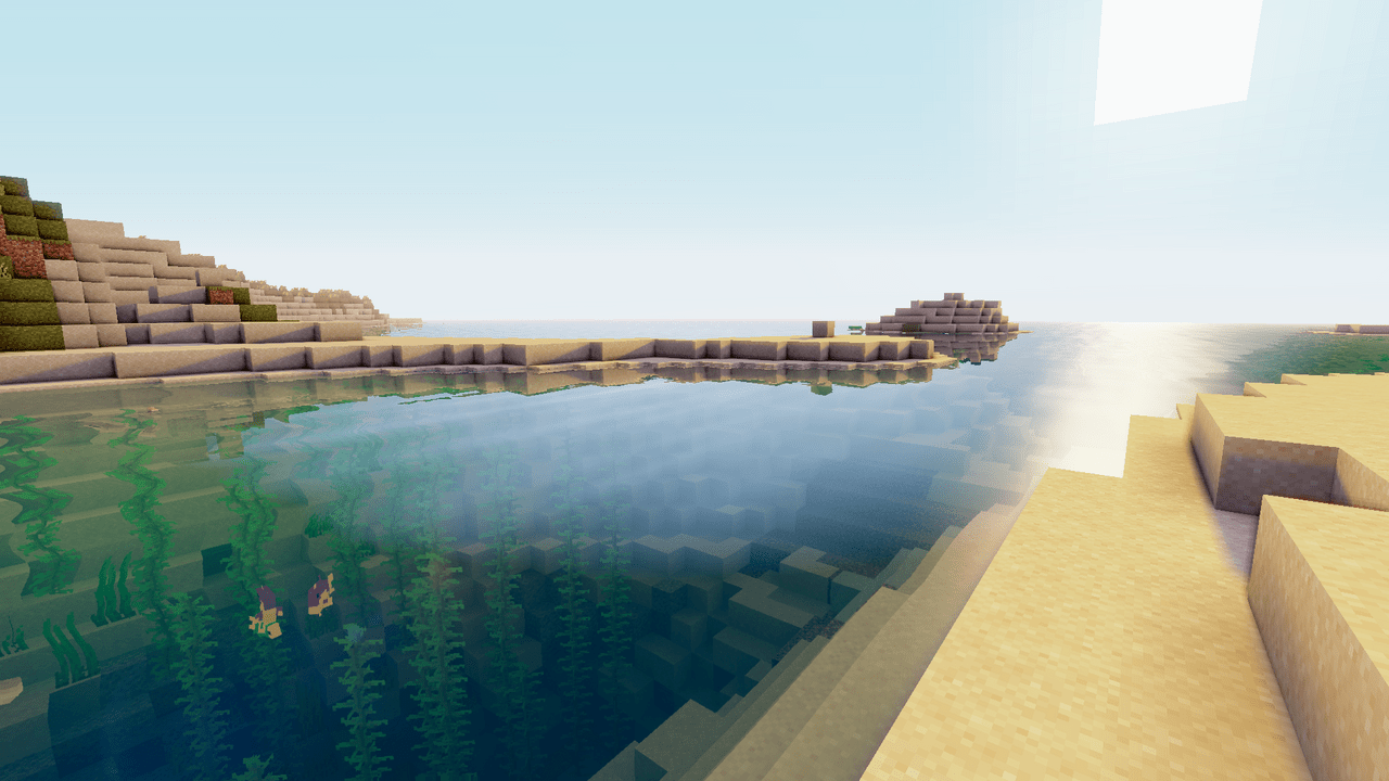 A Minecraft screenshot of a desert oasis with clear blue water. - Minecraft