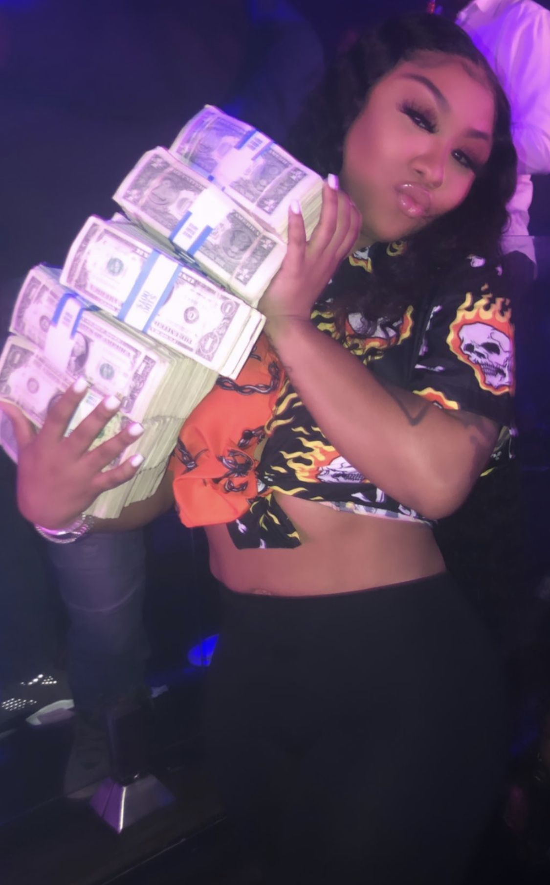 A woman holding stacks of money in her hands - Money