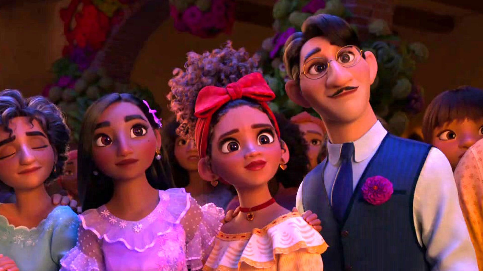 A still from the movie Encanto, showing a group of people with big smiles on their faces. - Encanto