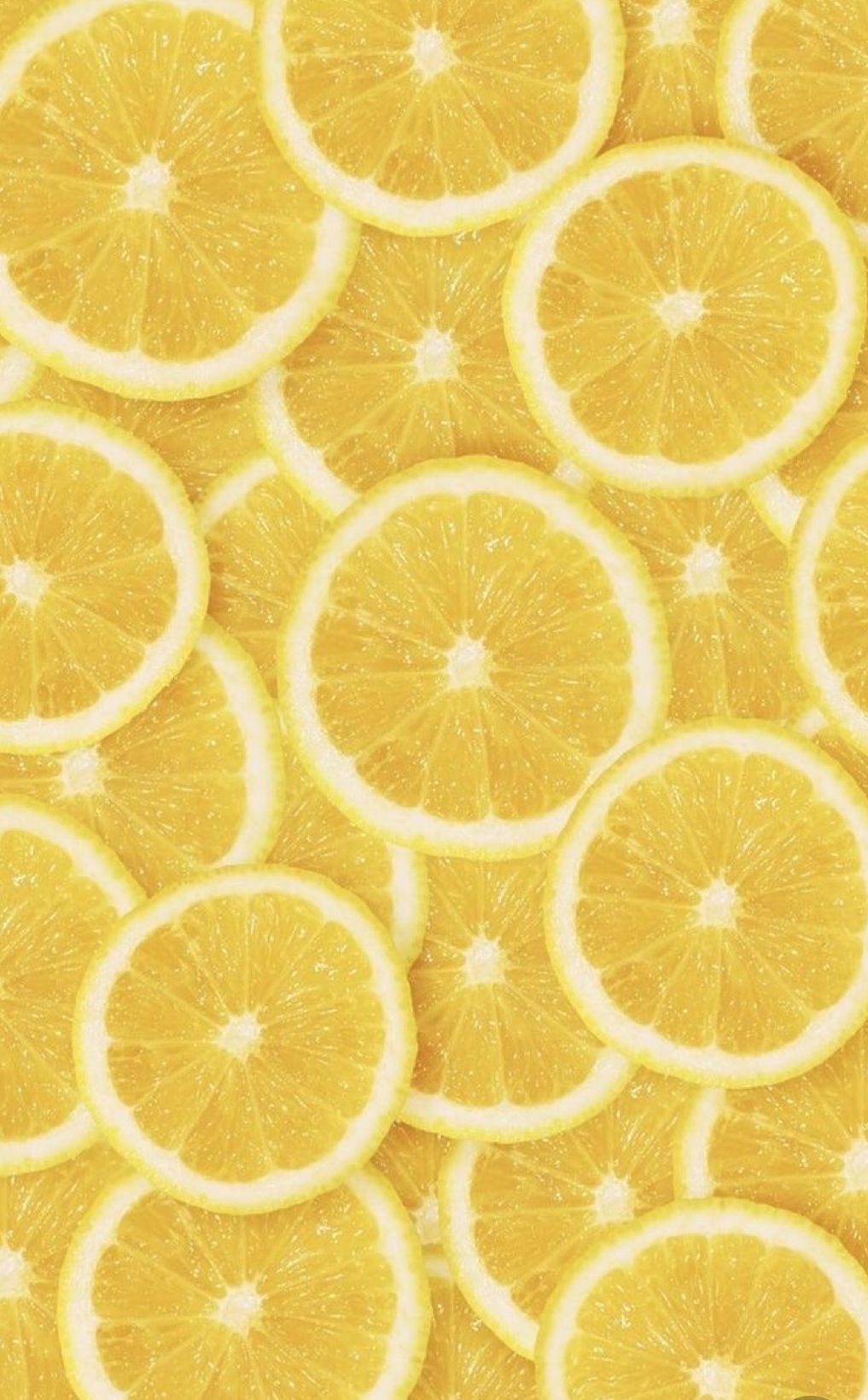 Yellow lemon slices on a yellow background - Lemon