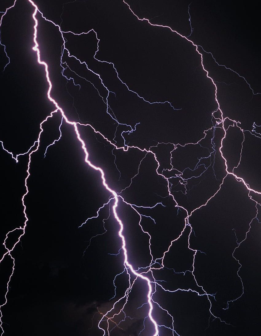 A lightning bolt strikes the ground in this photo - Lightning