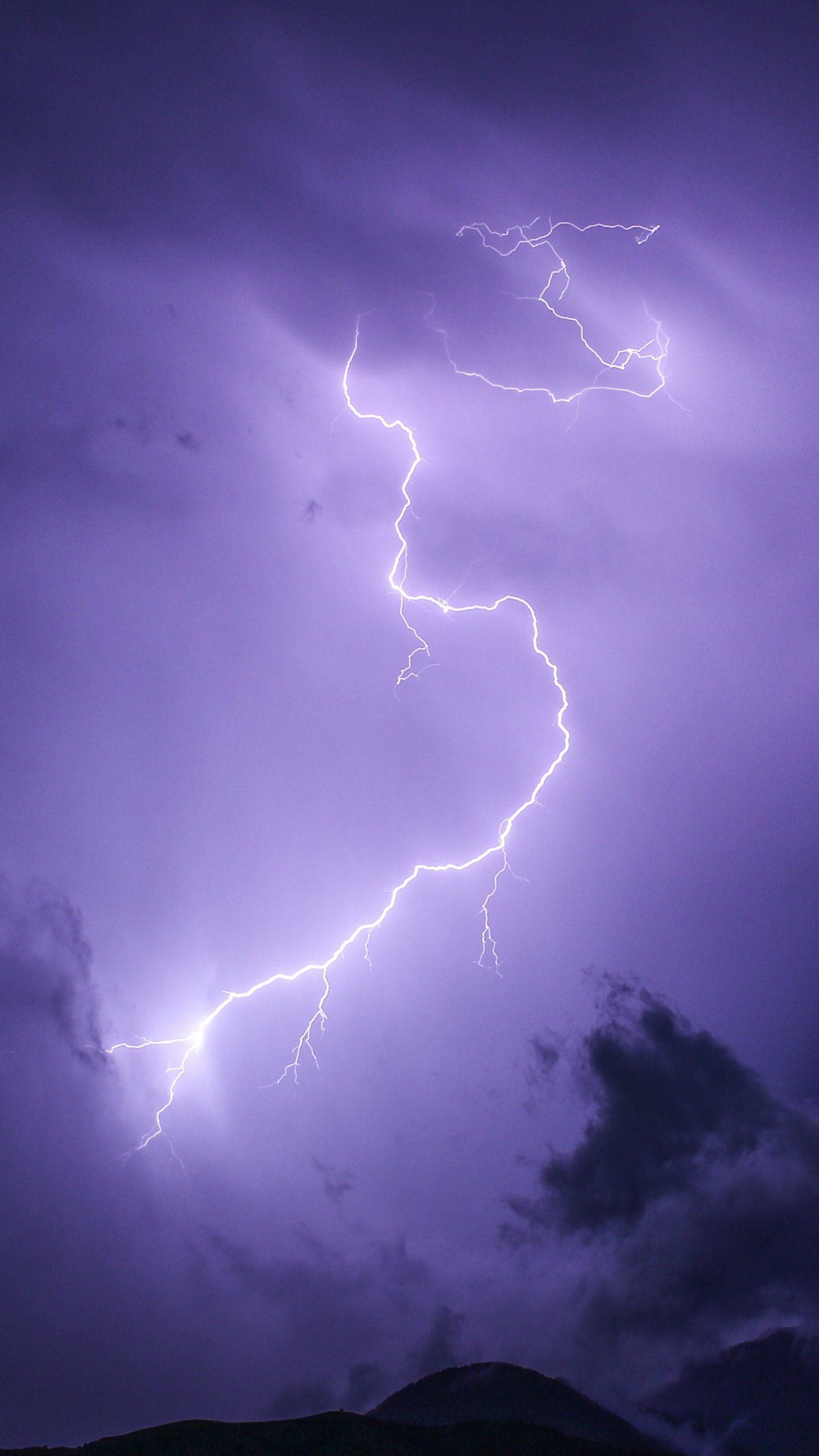 A bolt of lightning strikes during a storm in the sky - Lightning