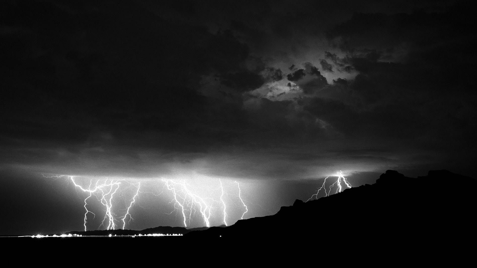 A black and white photo of lightning striking the ground - Lightning, storm