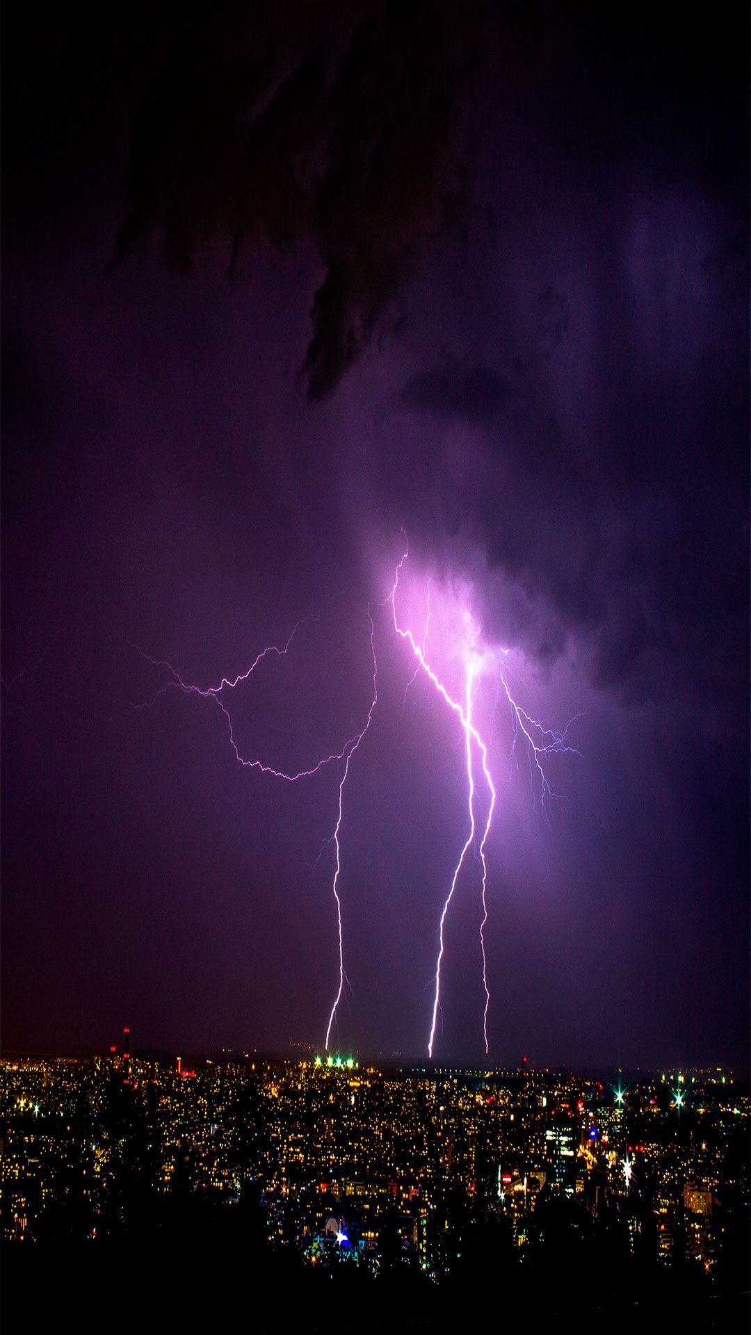 Lightning strikes over a city at night - Lightning