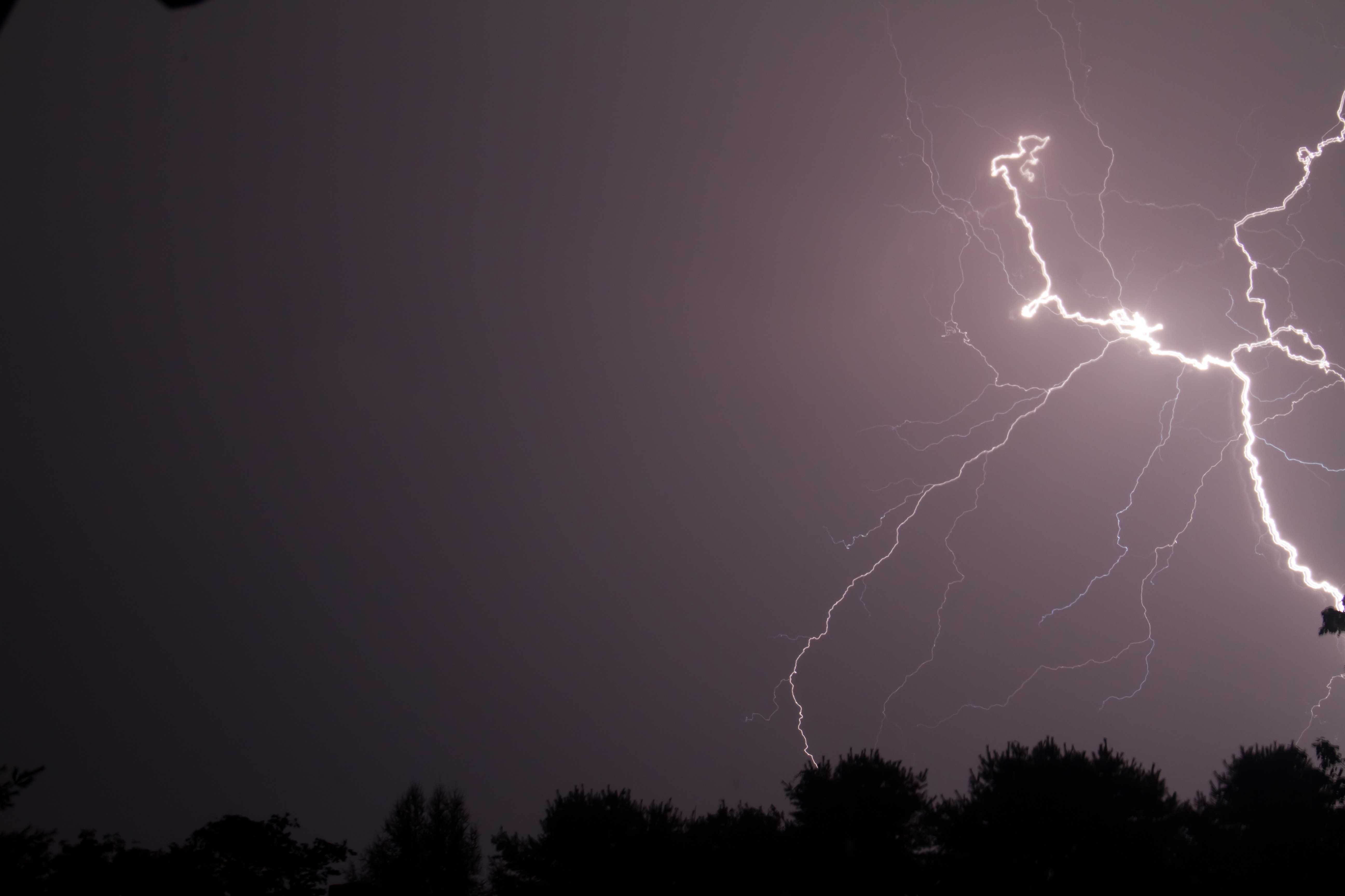 A large lightning bolt strikes in the sky. - Lightning, storm