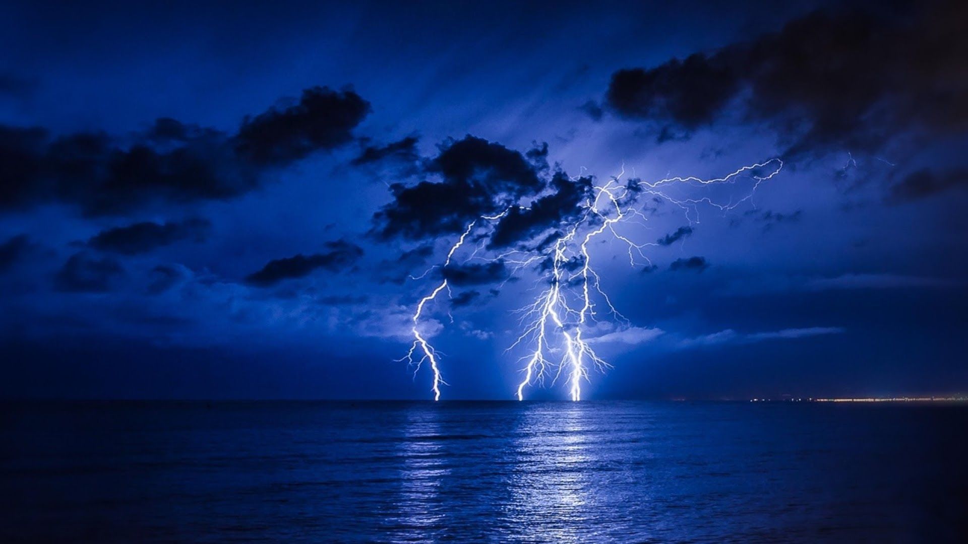 Lightning strikes over the ocean at night - Lightning