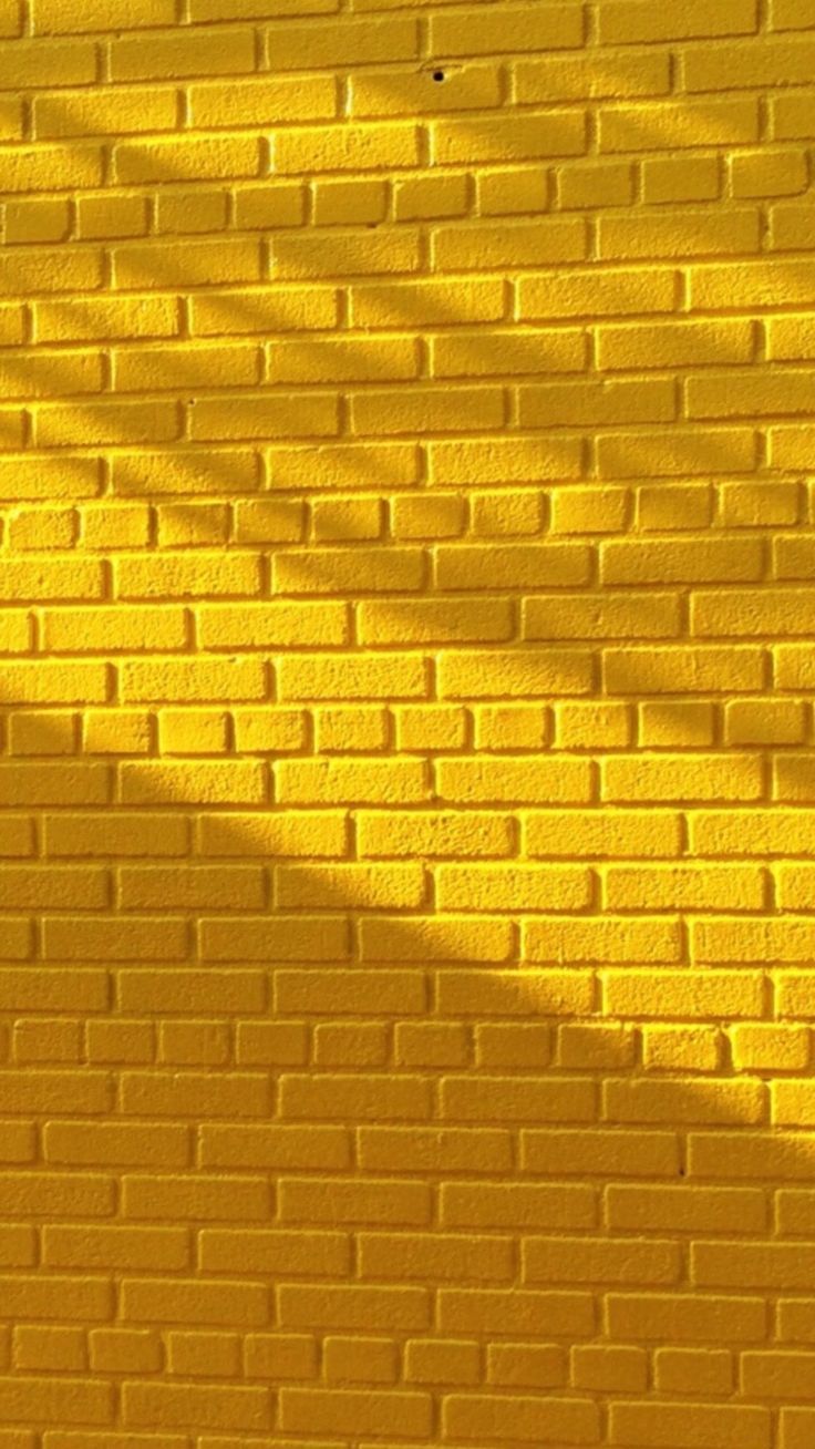 A yellow brick wall with shadows on it - Yellow iphone