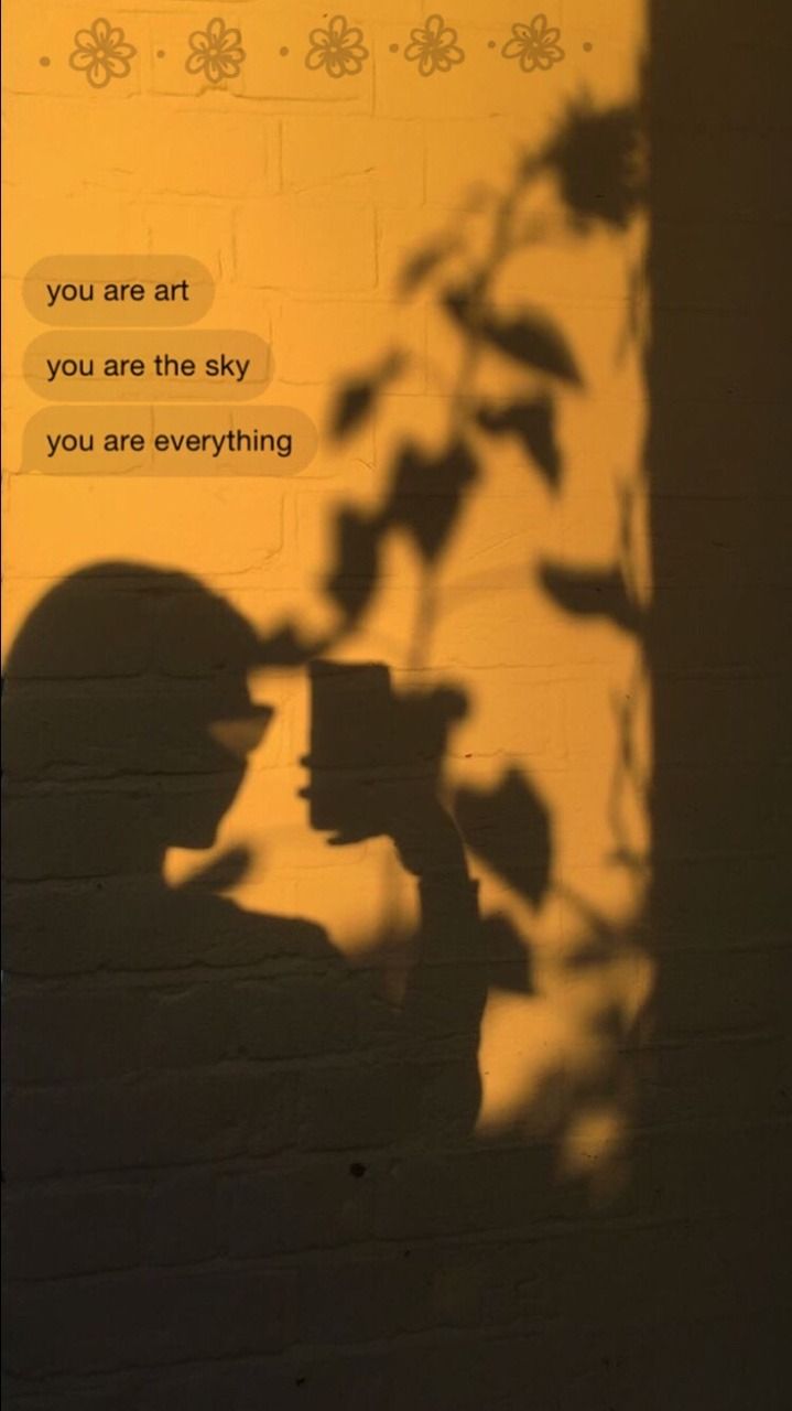A shadow of a person on a wall with text that says 