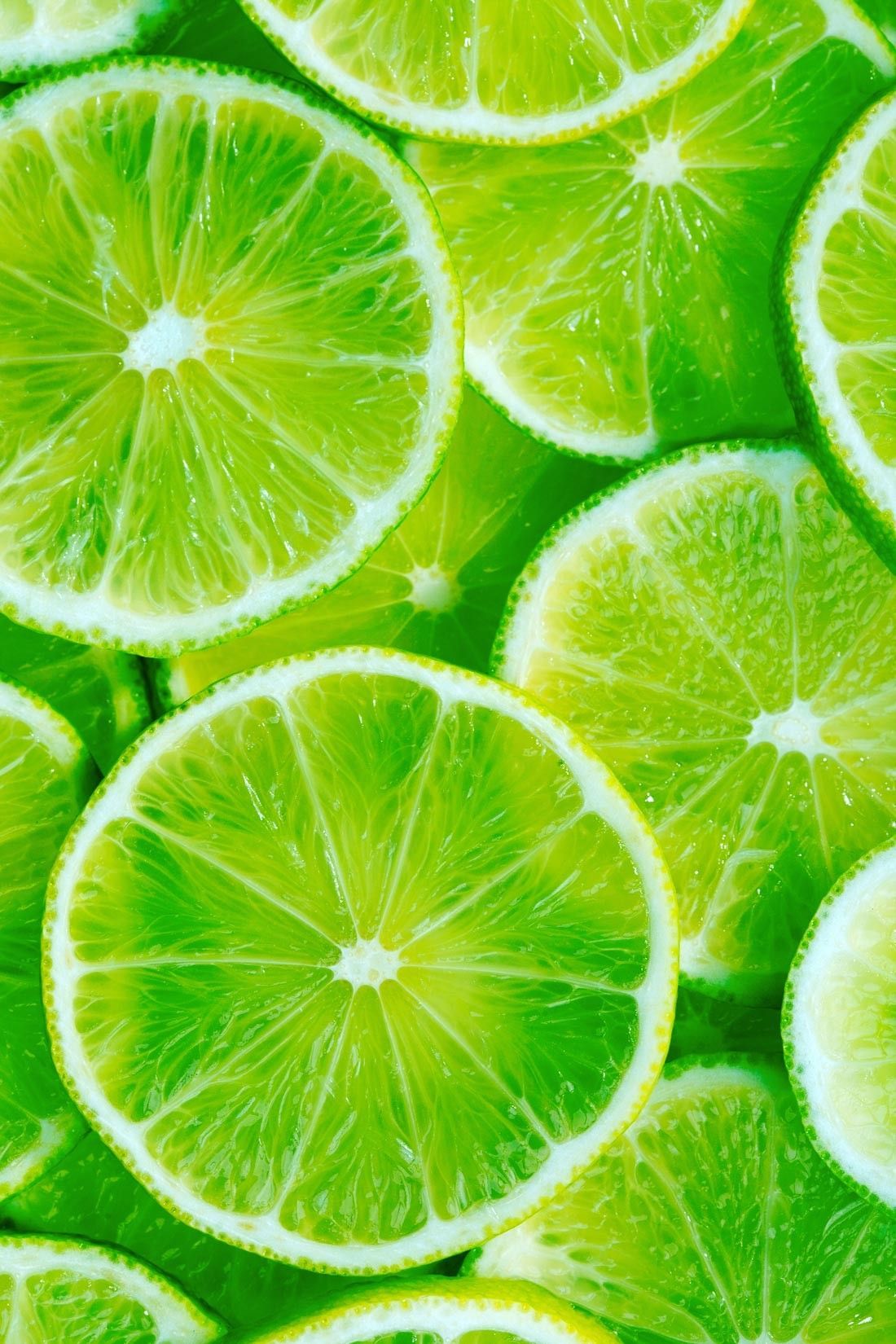 A close up of green lime slices. - Lemon, lime green