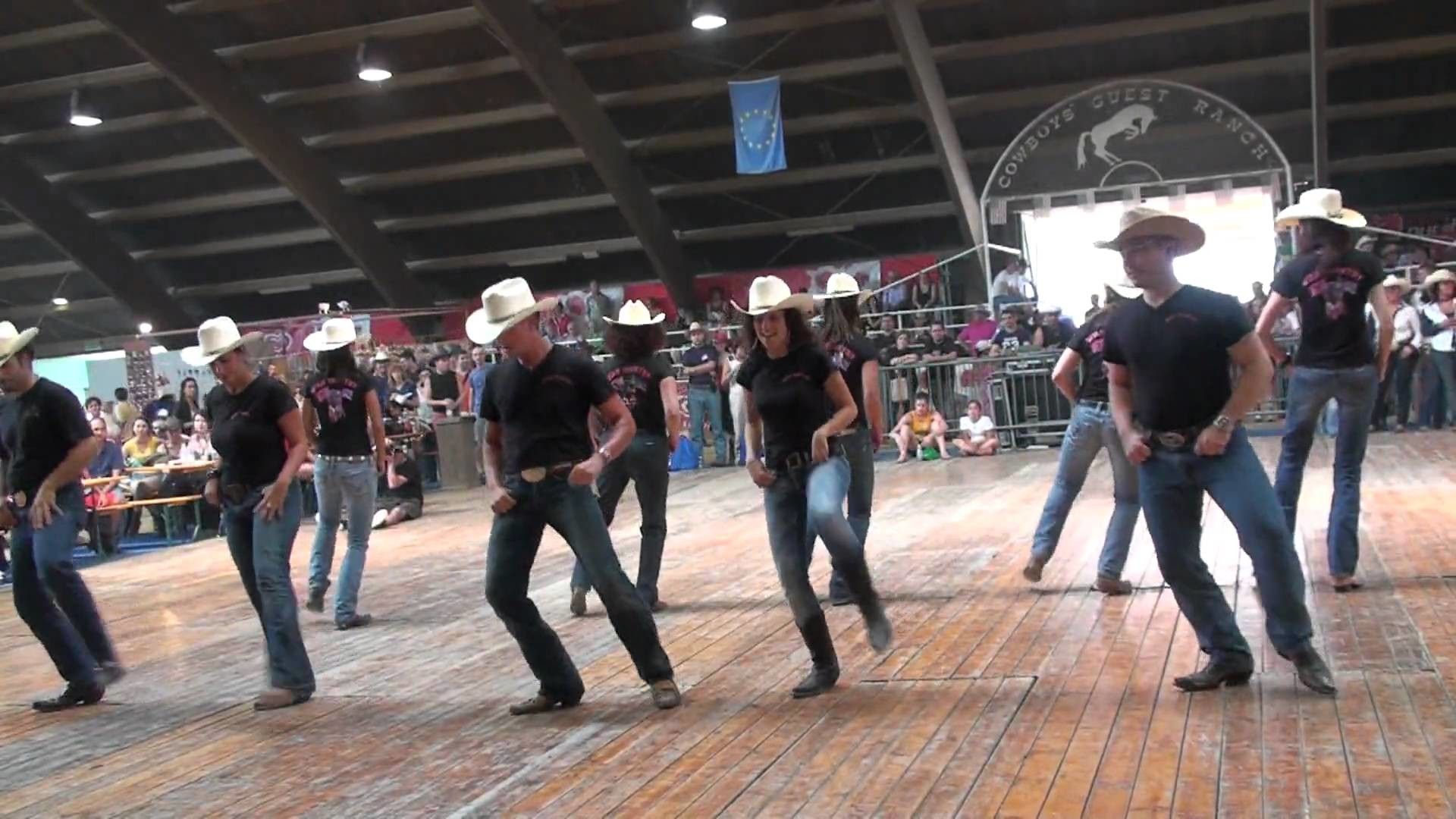 A group of people in cowboy hats dancing - Western